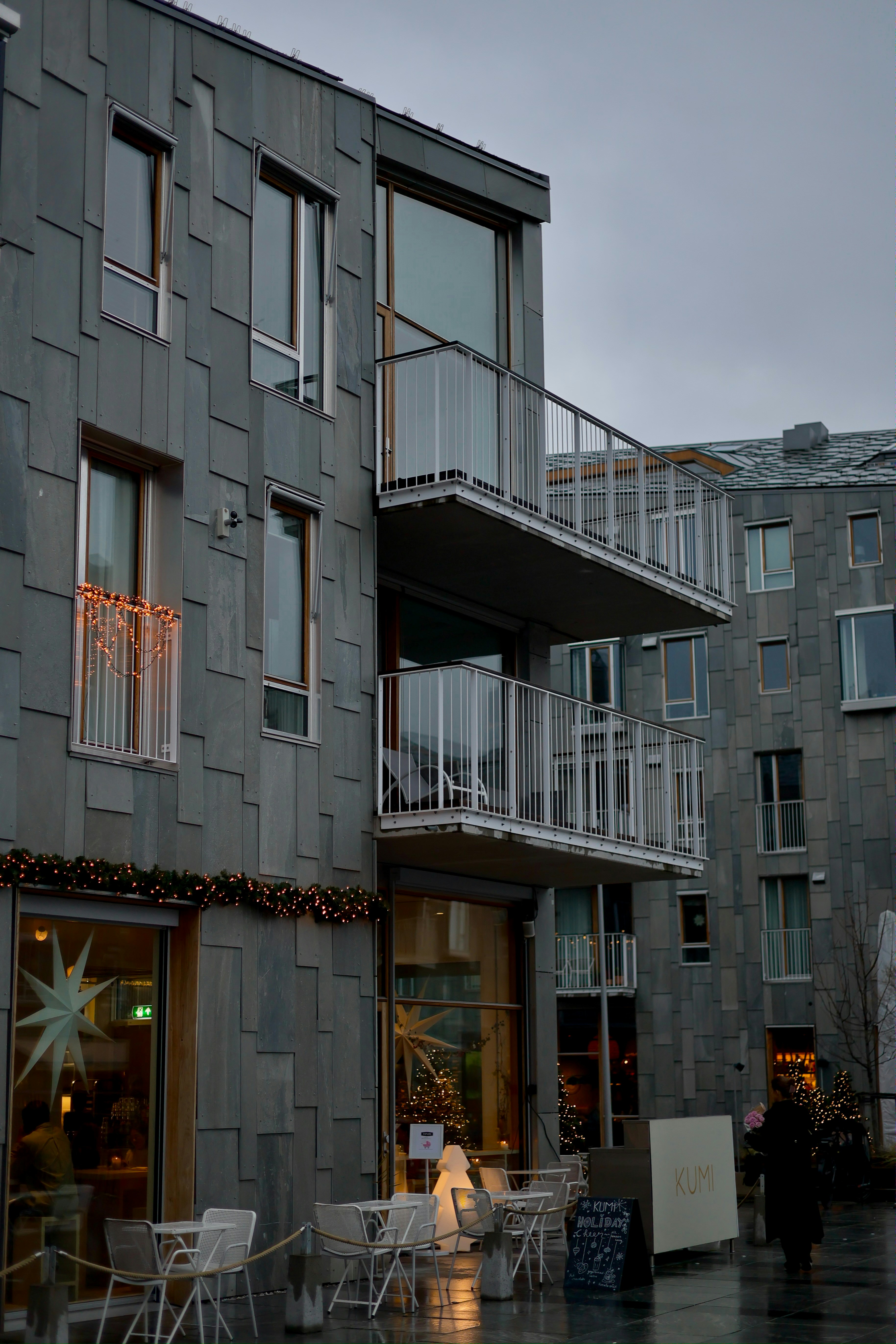Modern apartment buildings with balconies and festive lights