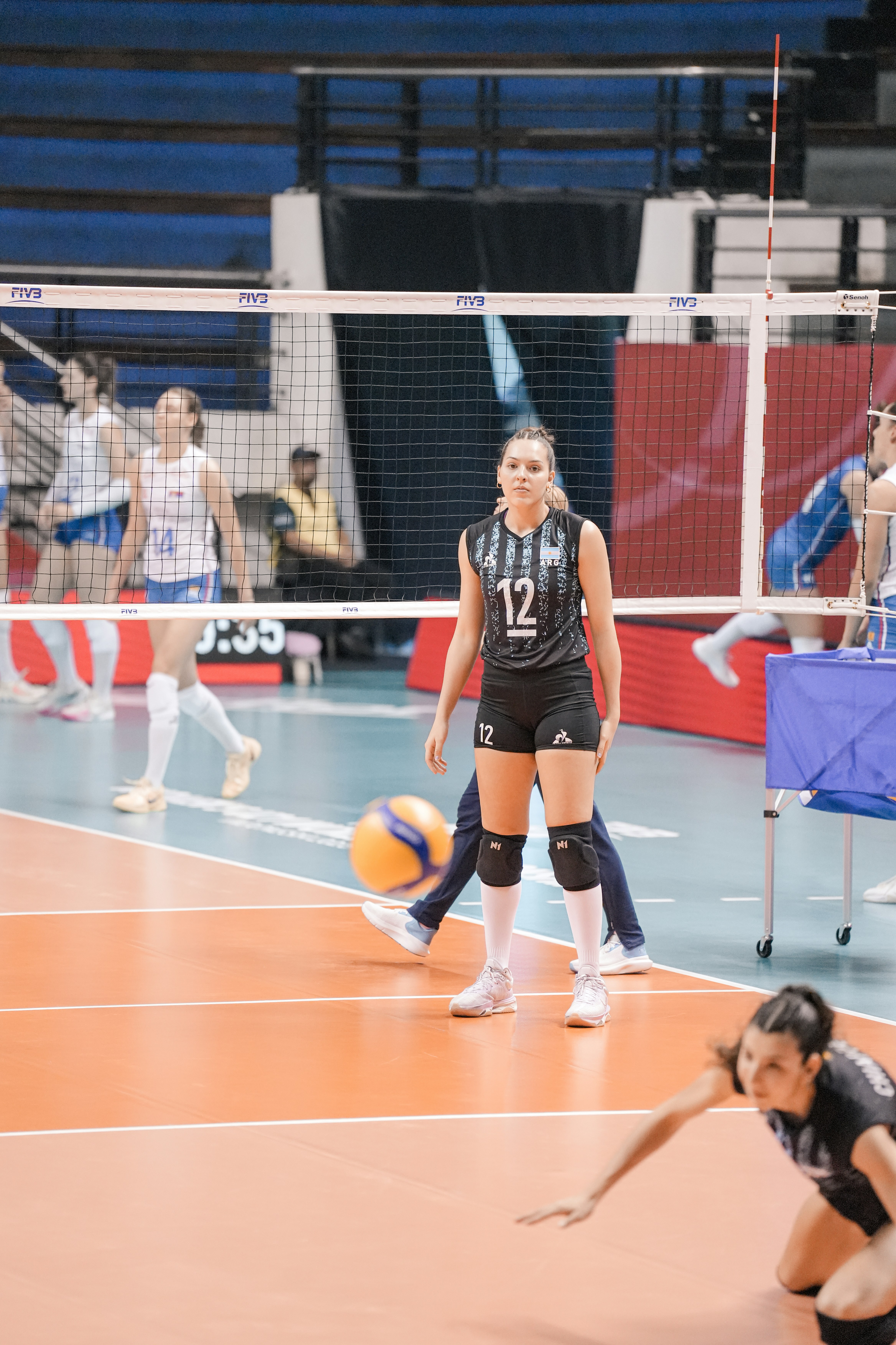 Volleyball player in black uniform on court
