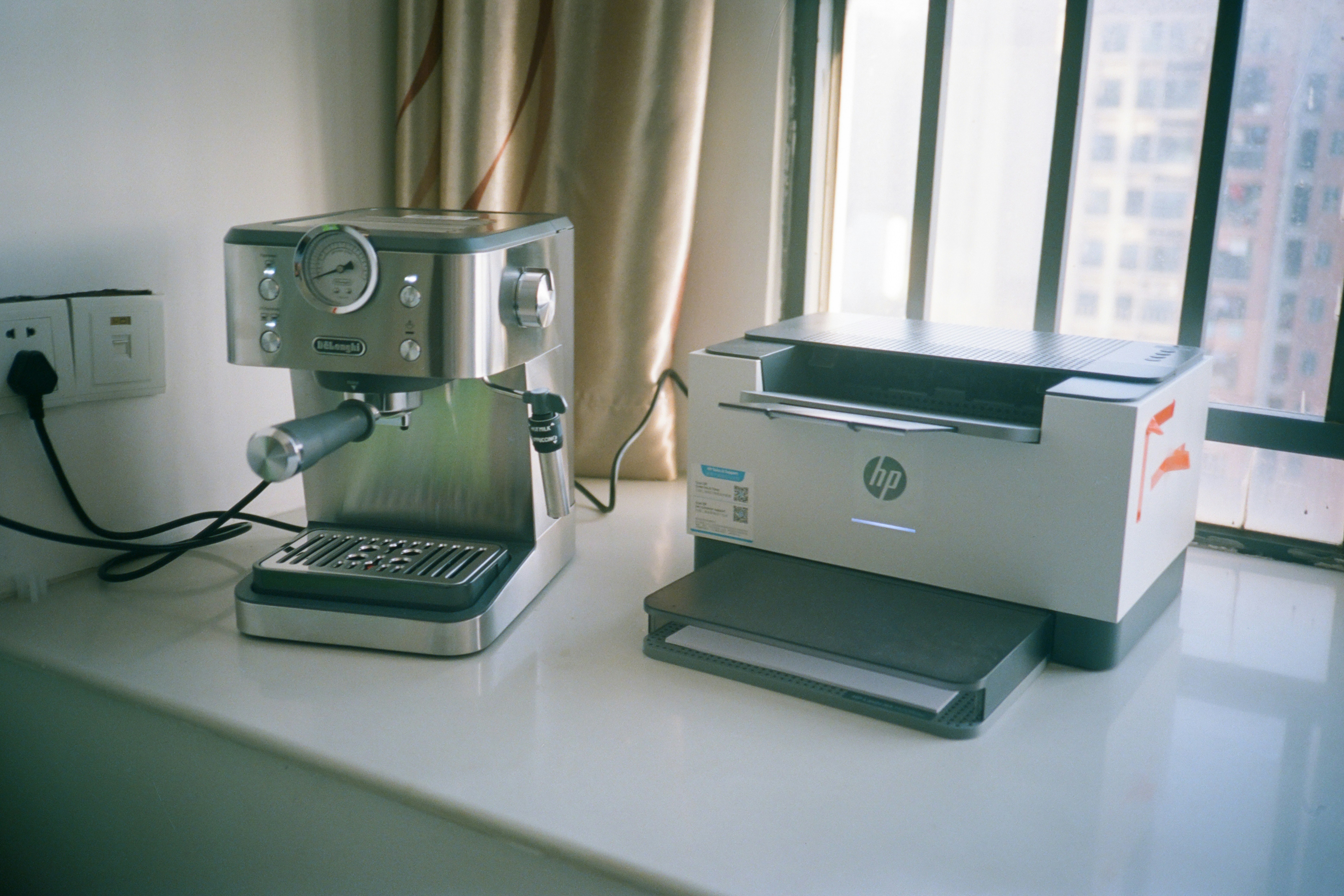 Espresso machine and hp printer on windowsill