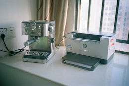Espresso machine and hp printer on windowsill