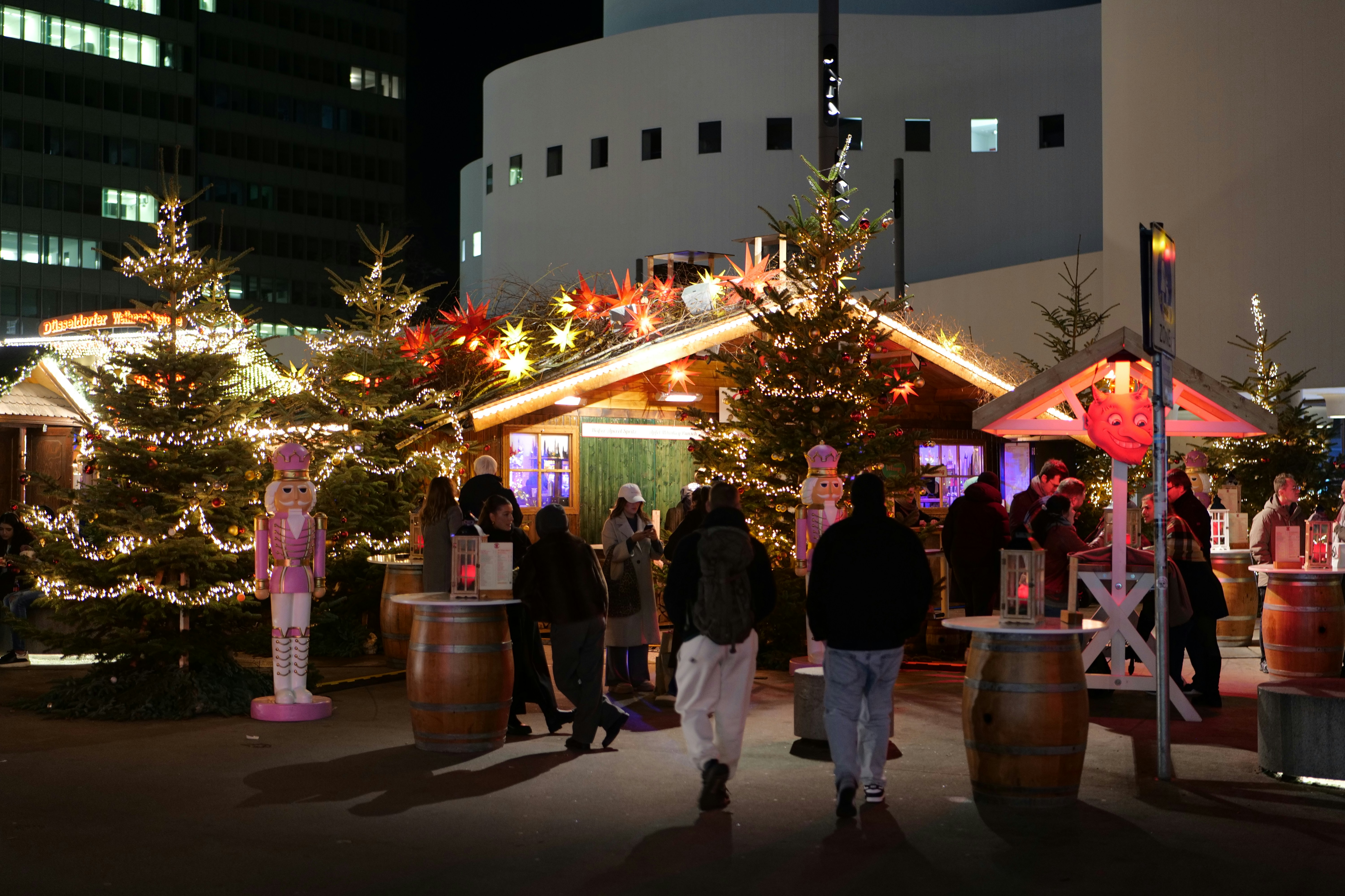 Christmas market with decorated trees and stalls at night