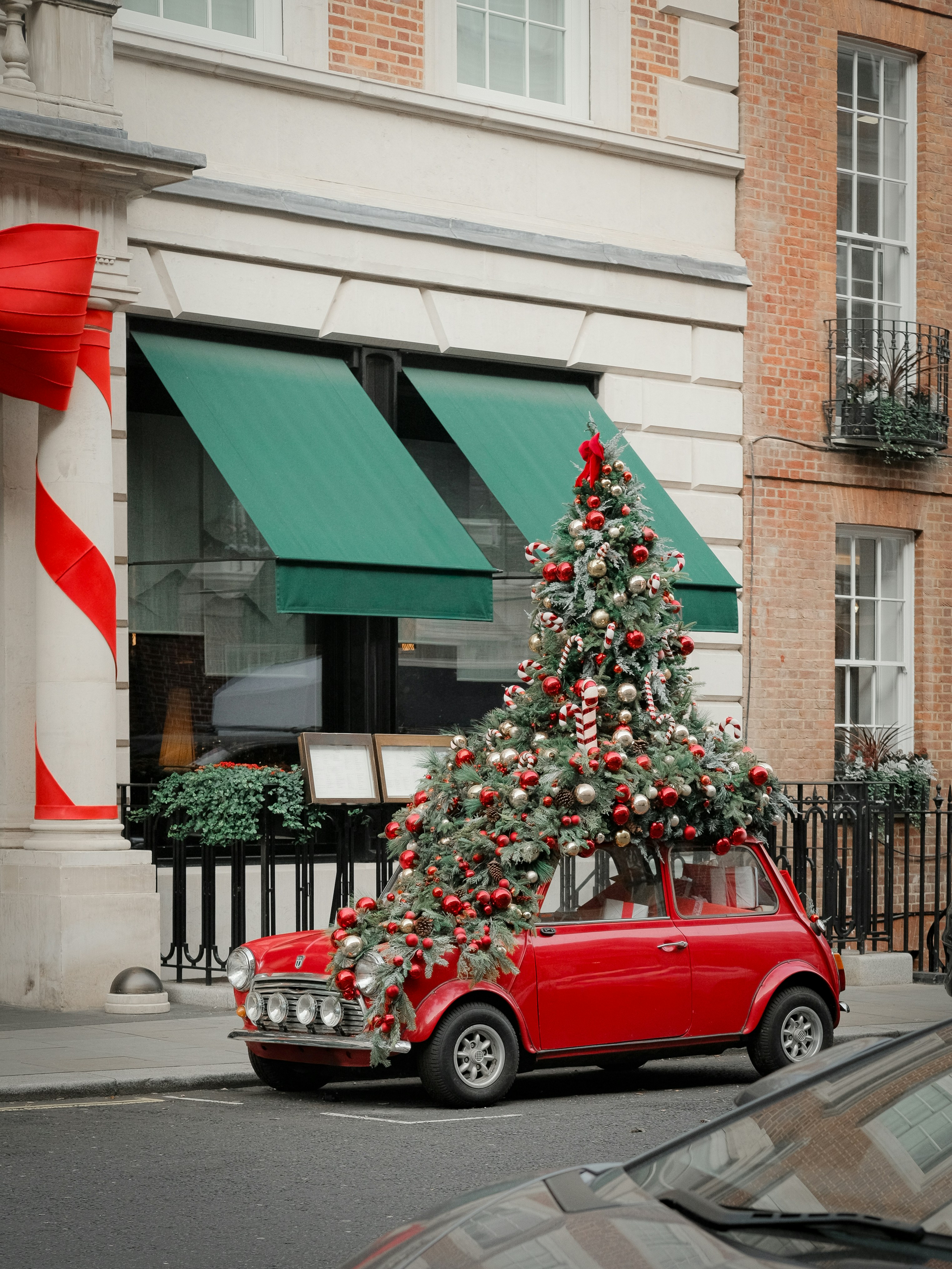 Red car decorated with a christmas tree