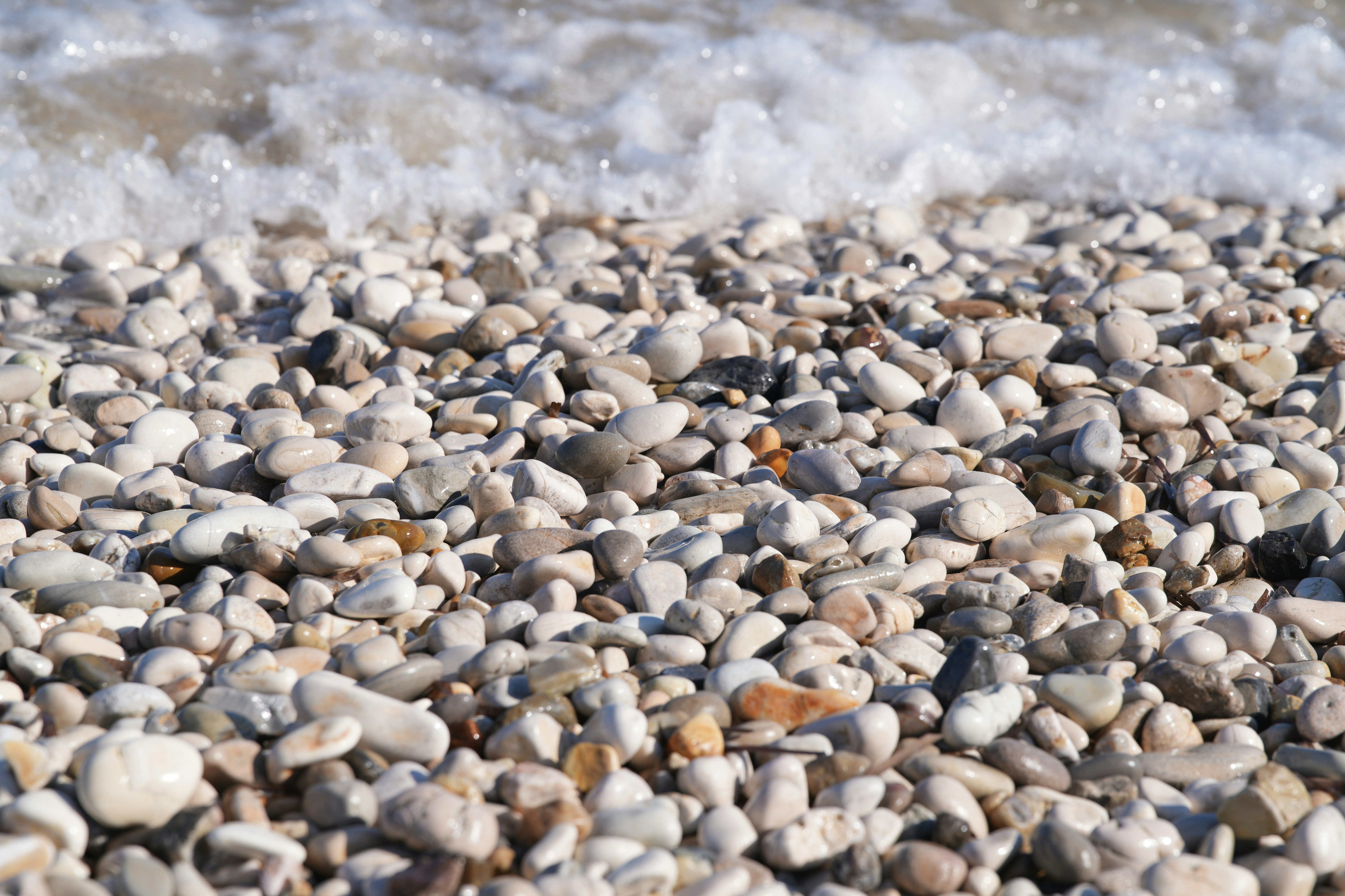 Pebble beach with gentle waves washing ashore