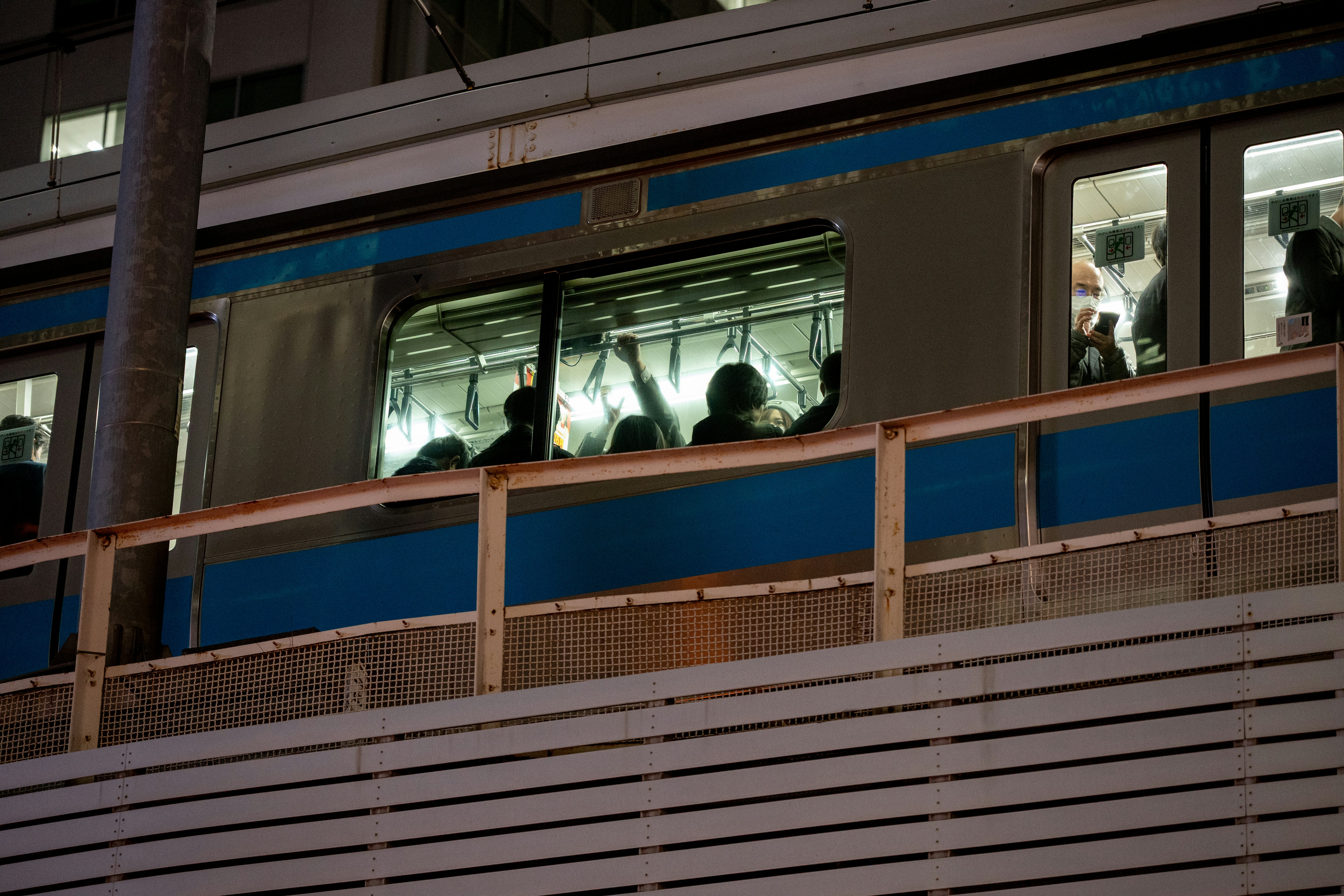 People inside a moving train at night