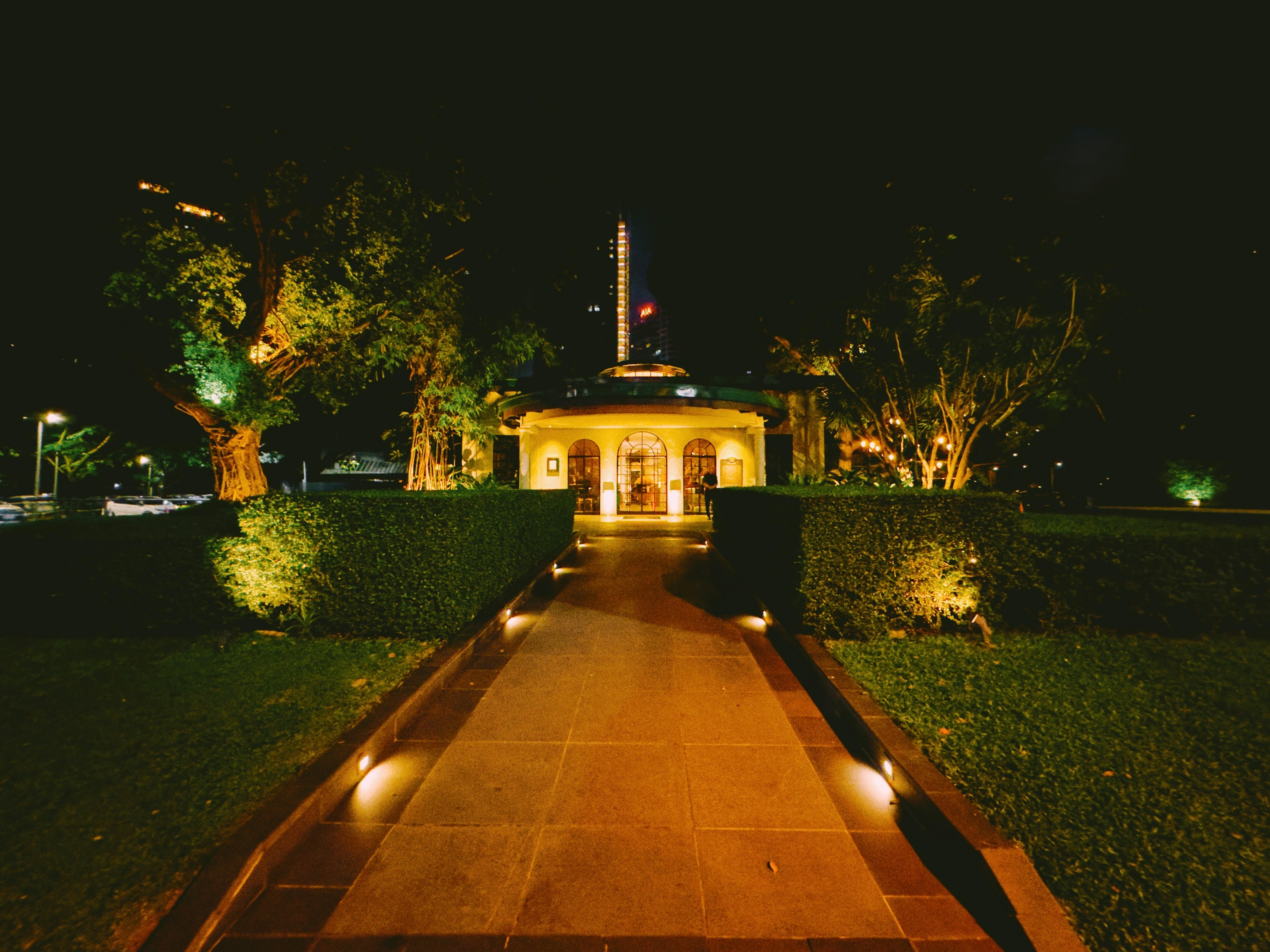 Pathway leading to a lit building at night