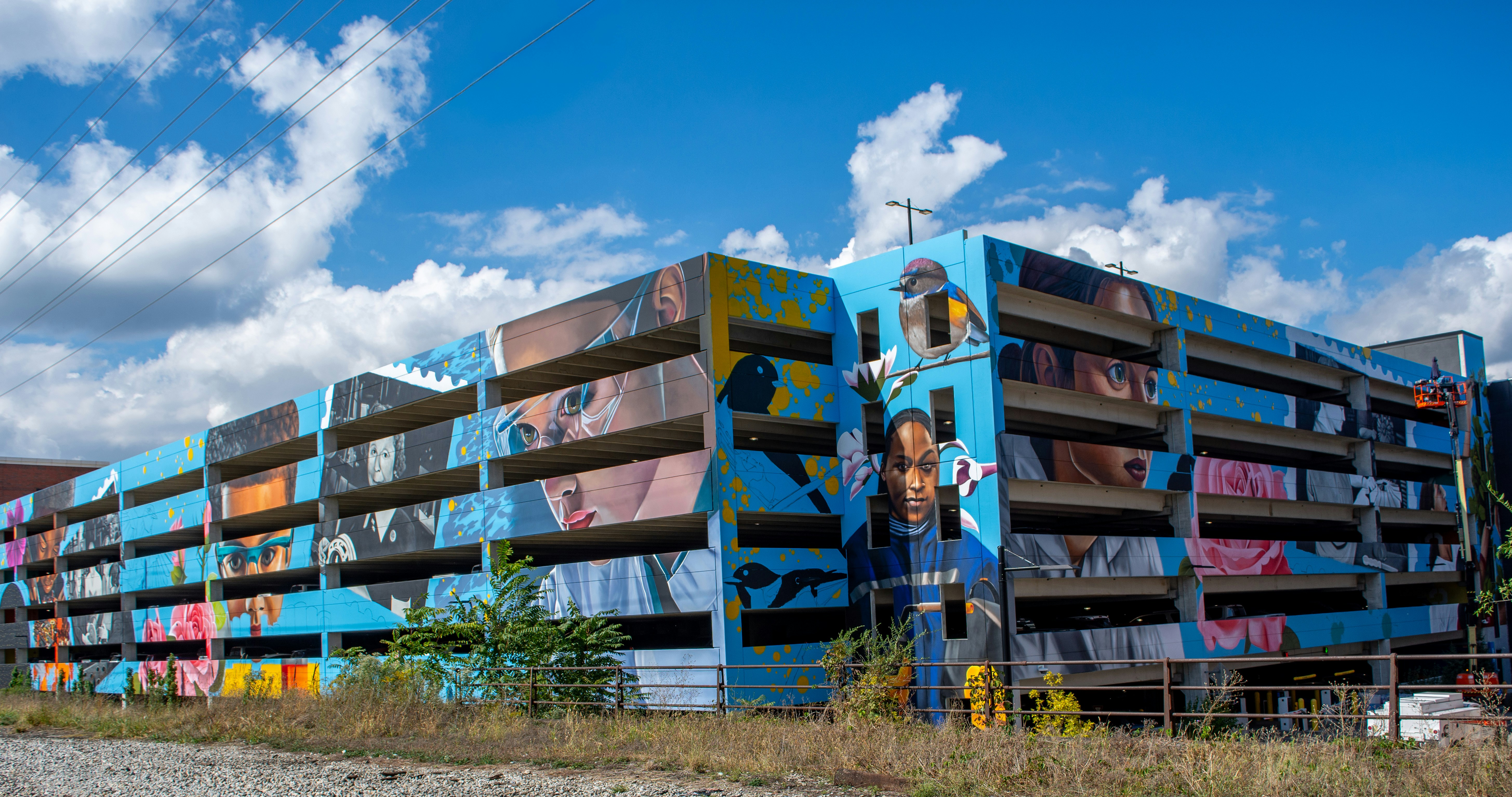 Graffiti art covers a multi-story parking garage.