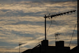 Silhouette of antennas against a cloudy sky