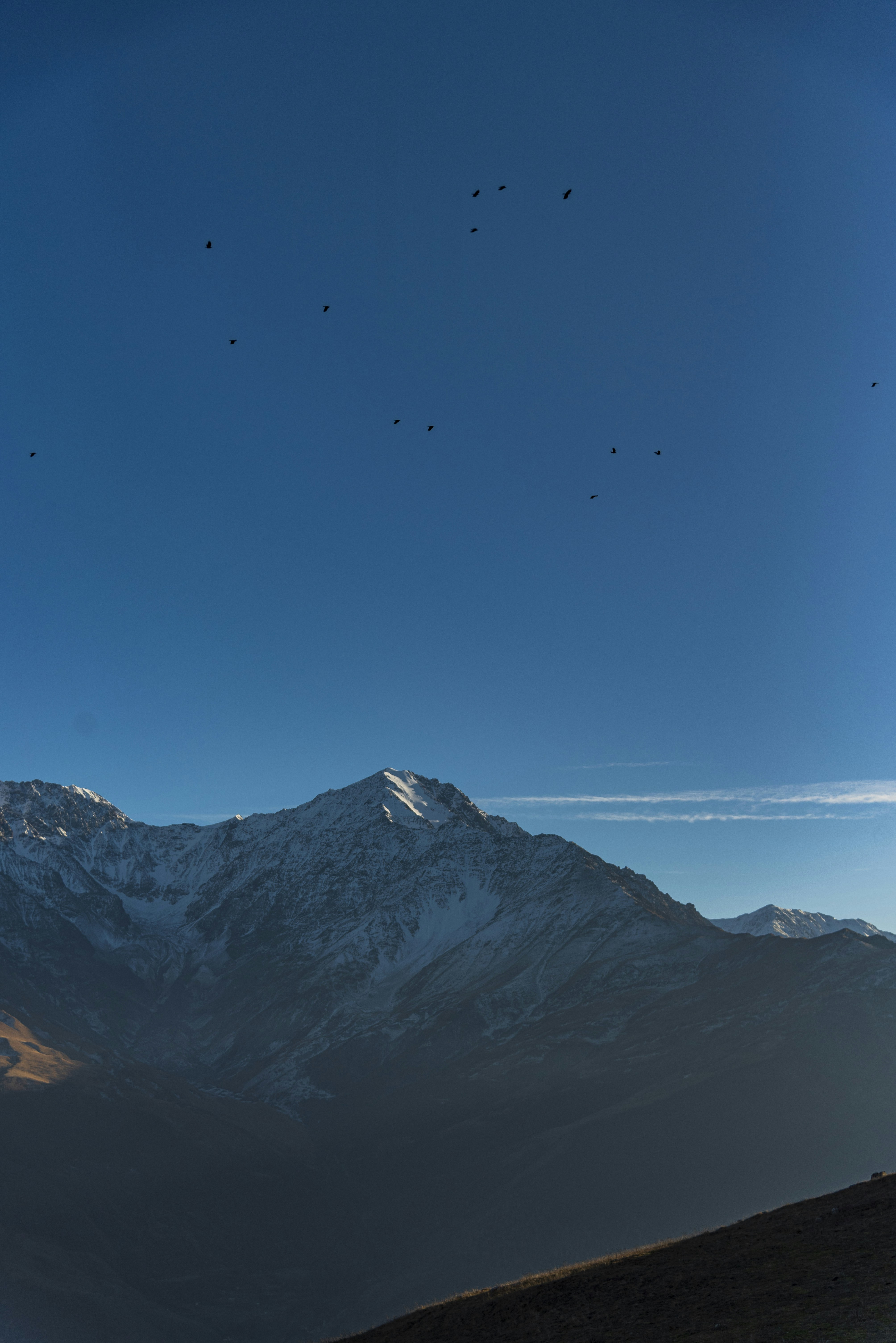 Snow-capped mountain range under a clear blue sky
