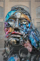 Sculpture of a human face made from recycled metal parts.