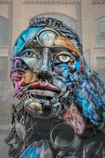 Sculpture of a human face made from recycled metal parts.