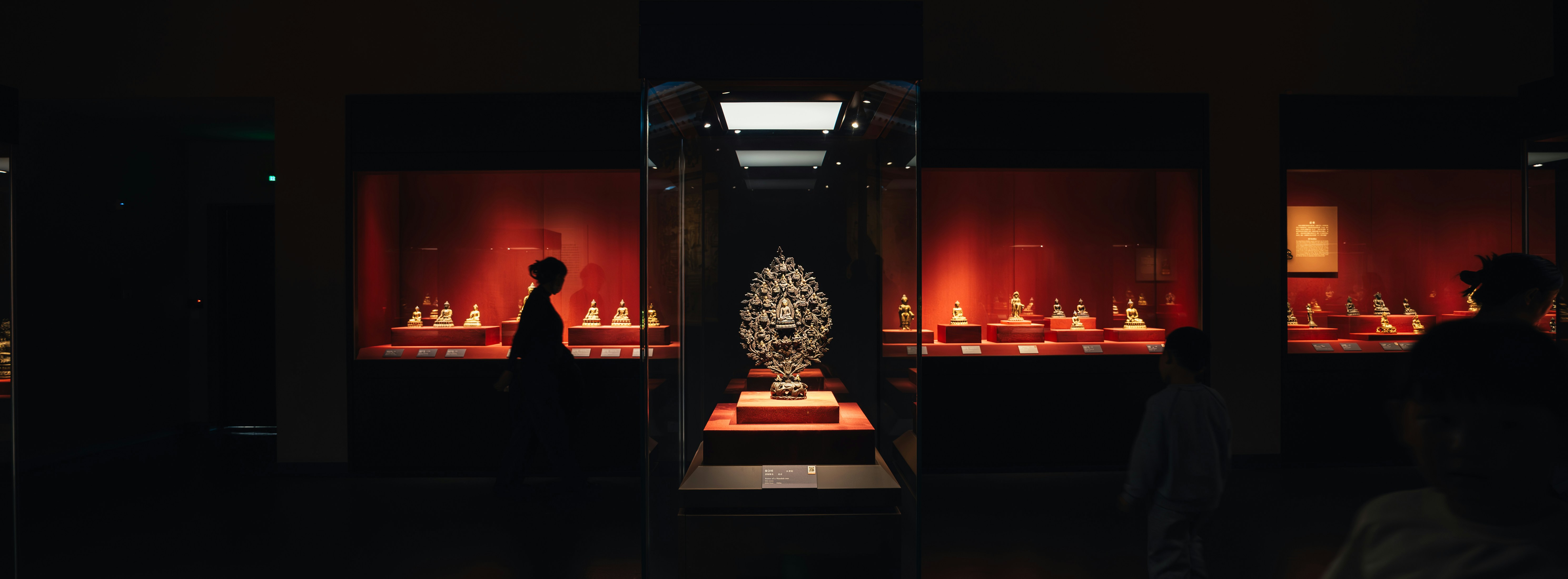 Artifact displayed in a museum exhibit with red lighting.