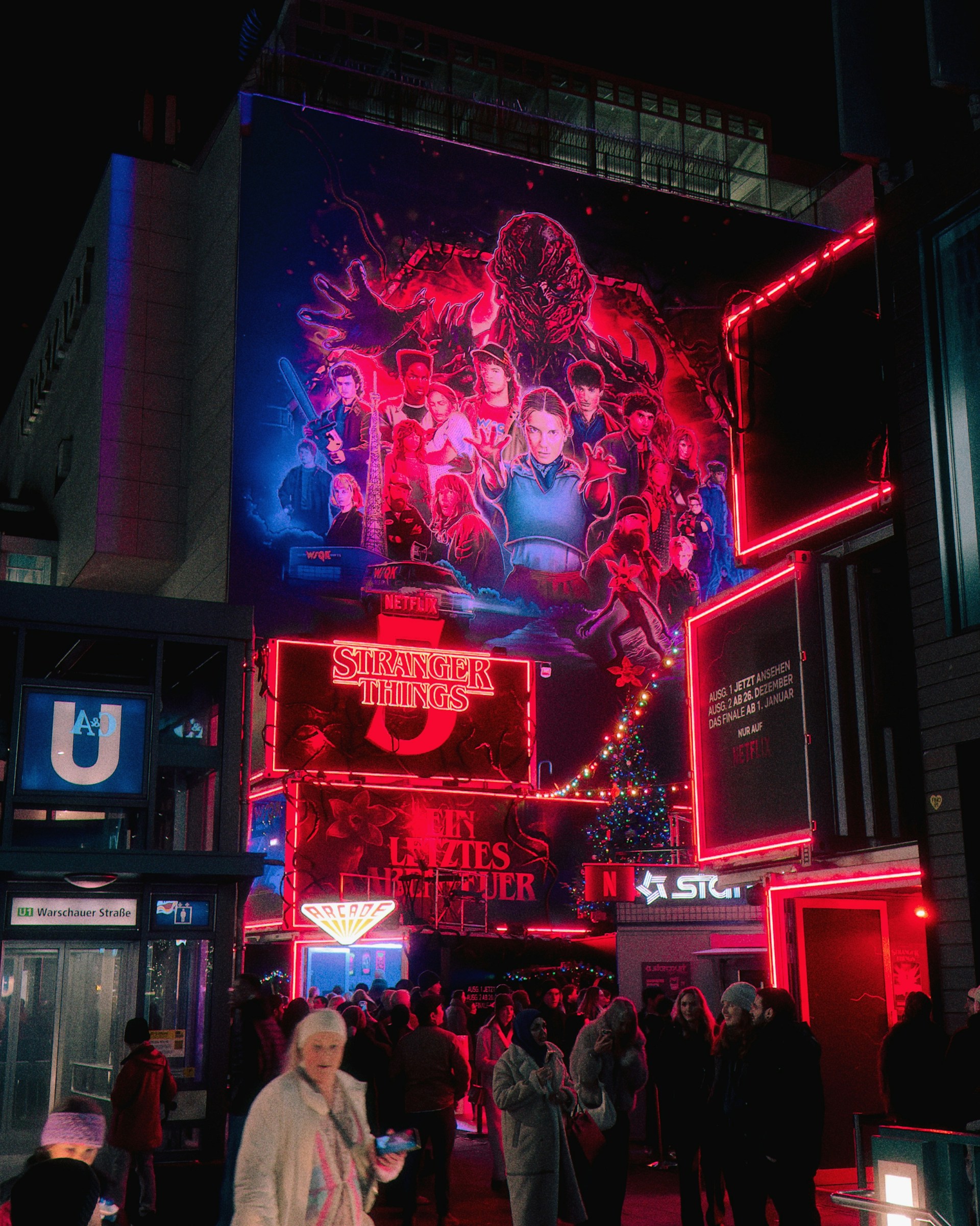 Stranger things mural on a building at night