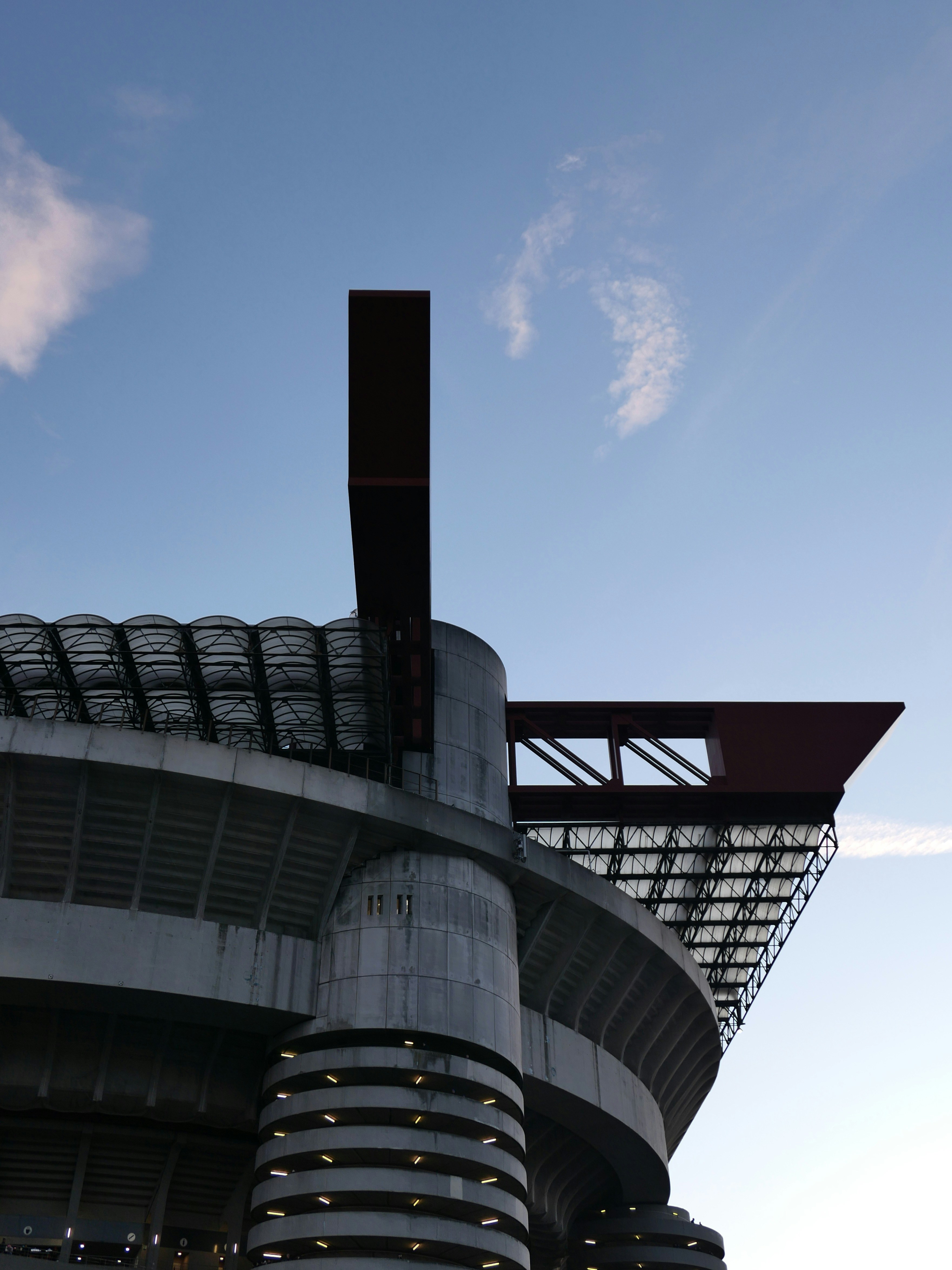 Modern stadium architecture against a blue sky