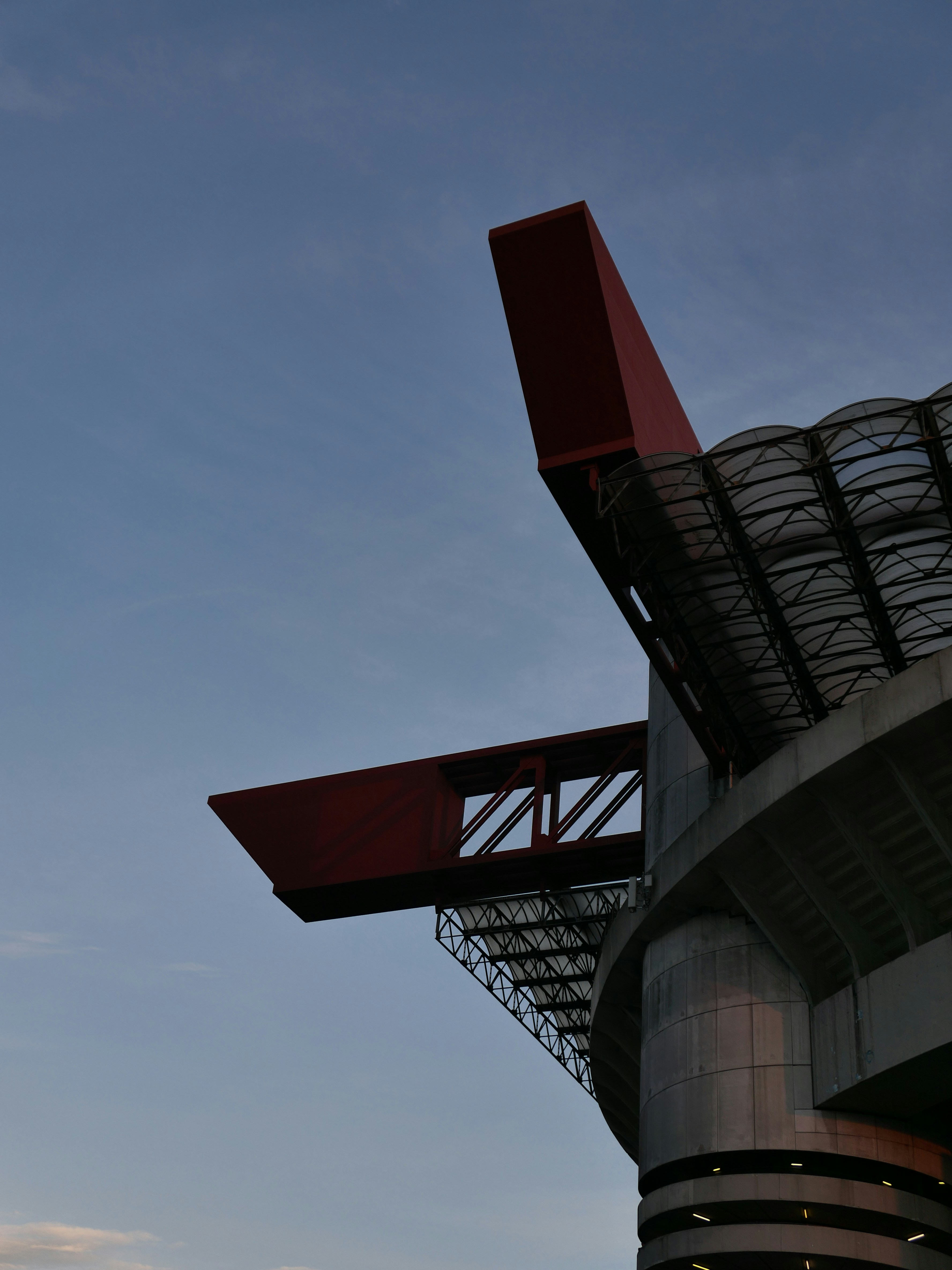Modern stadium architecture against a clear blue sky