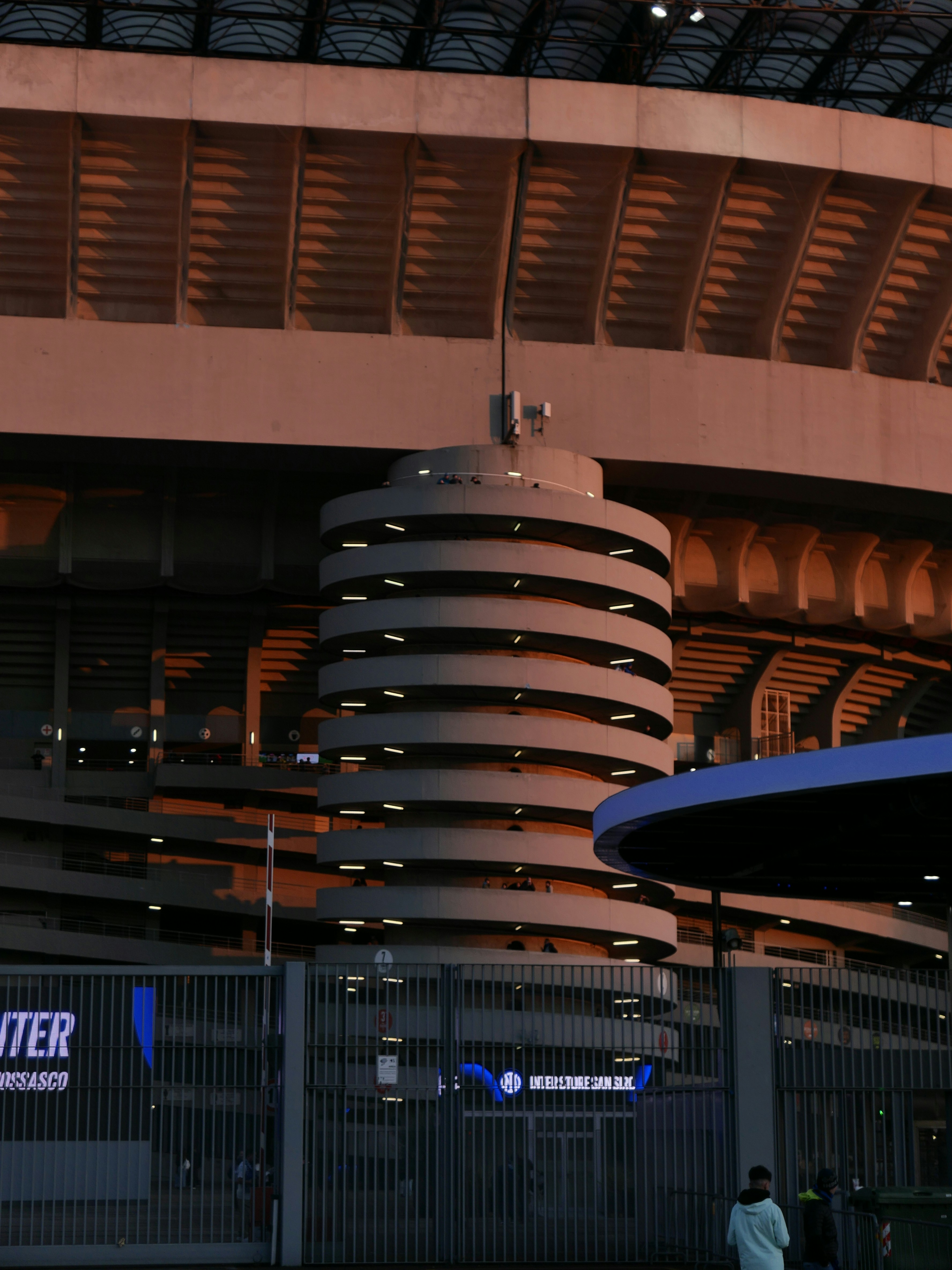 Modern stadium exterior with circular tower detail