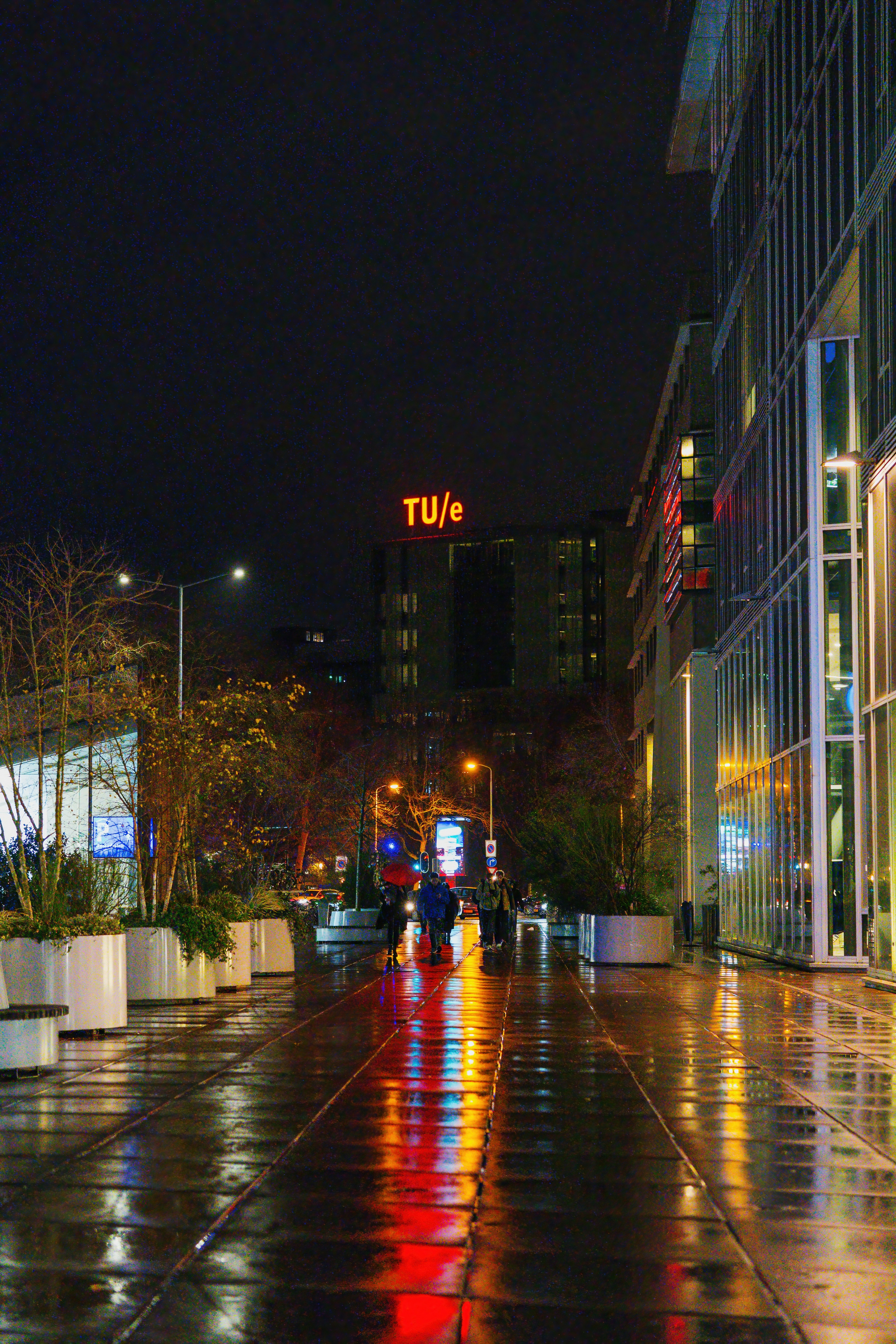 Wet city street at night with building reflections