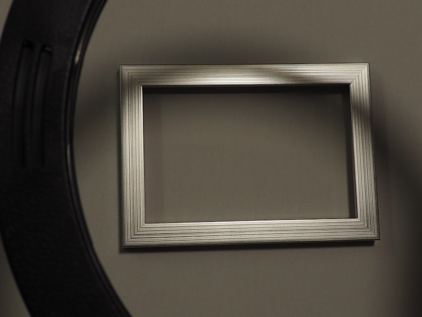 Empty silver picture frame on a gray background.