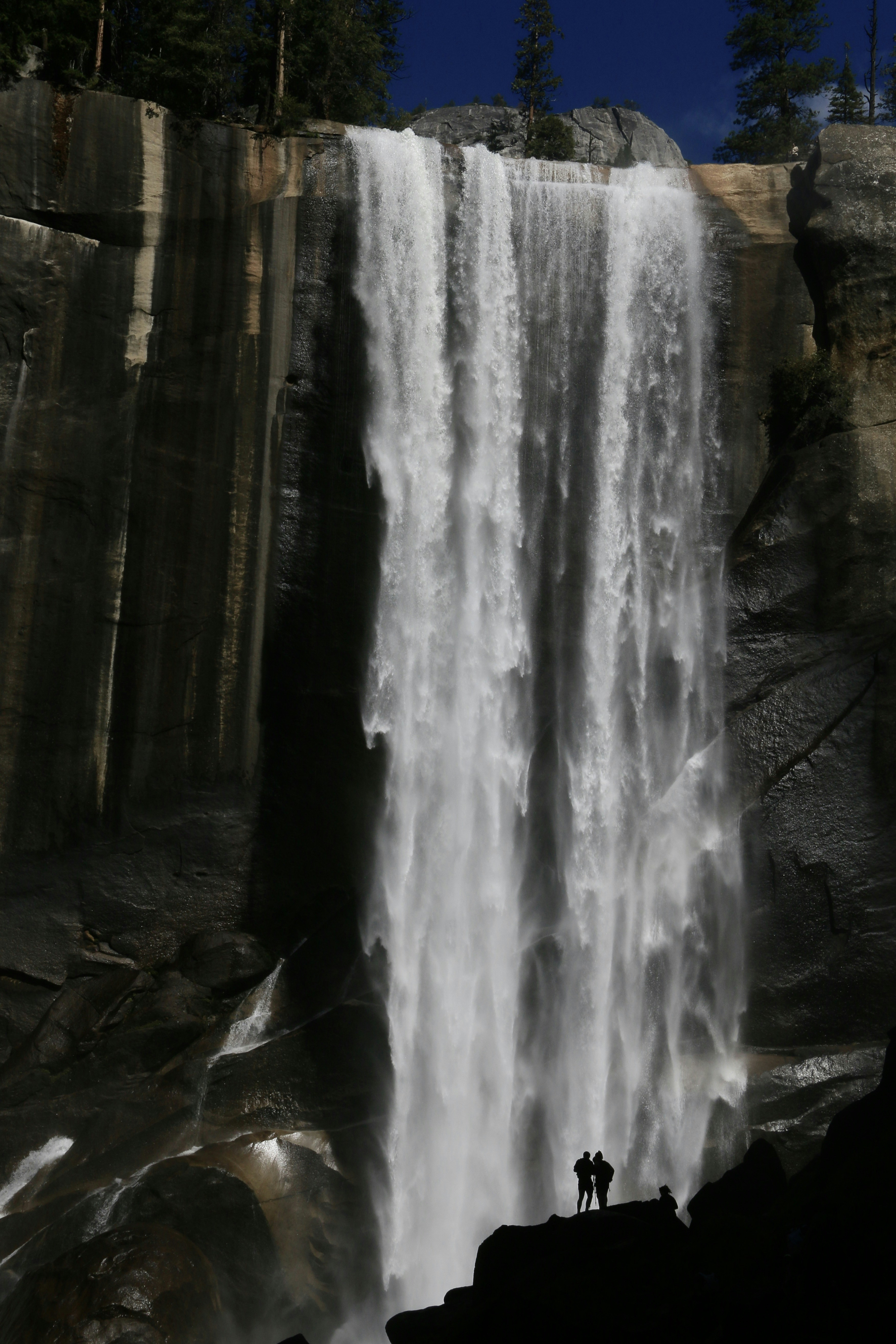 Powerful waterfall cascades down a rocky cliff face.