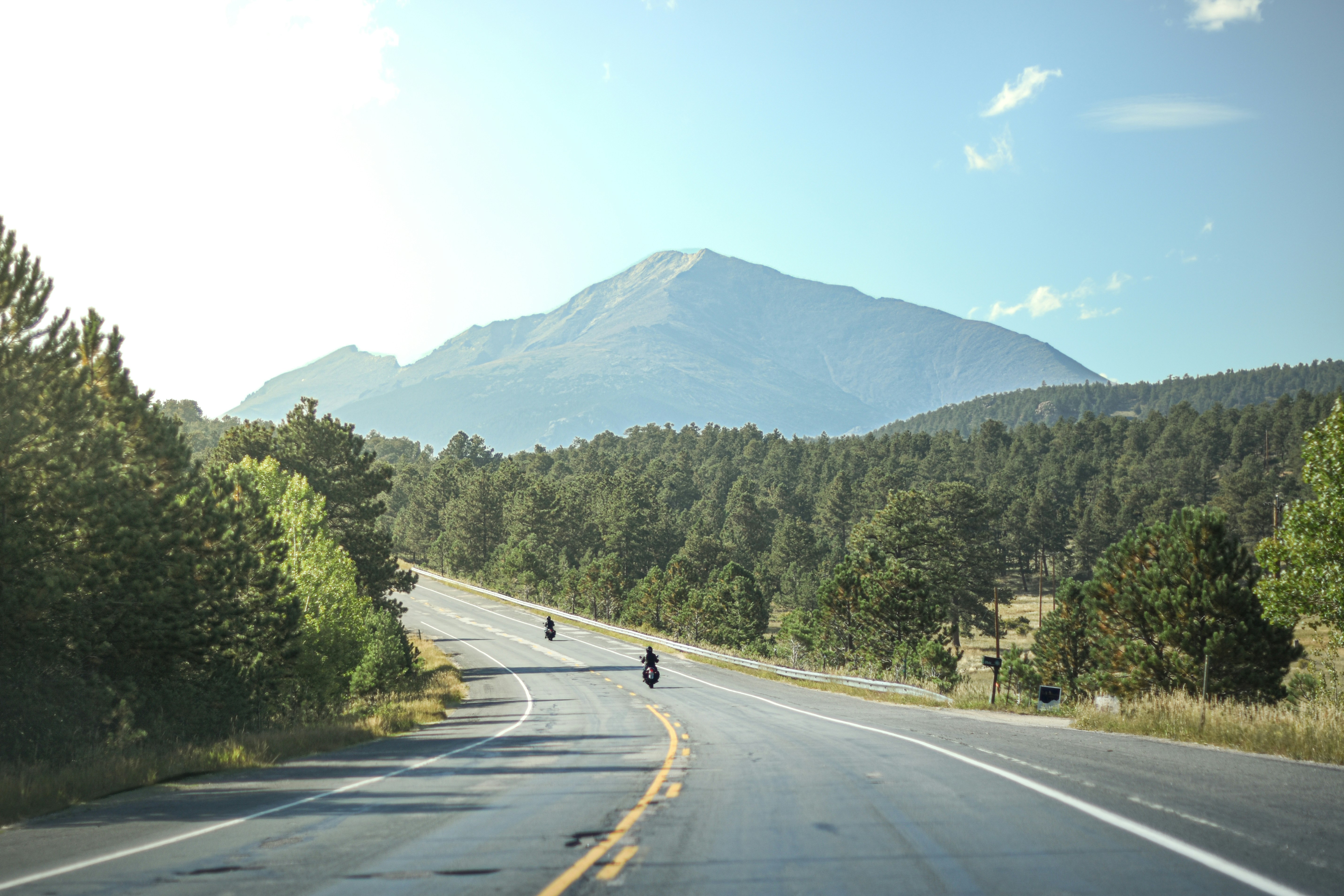 A winding road leads to a large mountain.