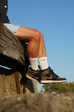 Man wearing brown and black high-top sneakers