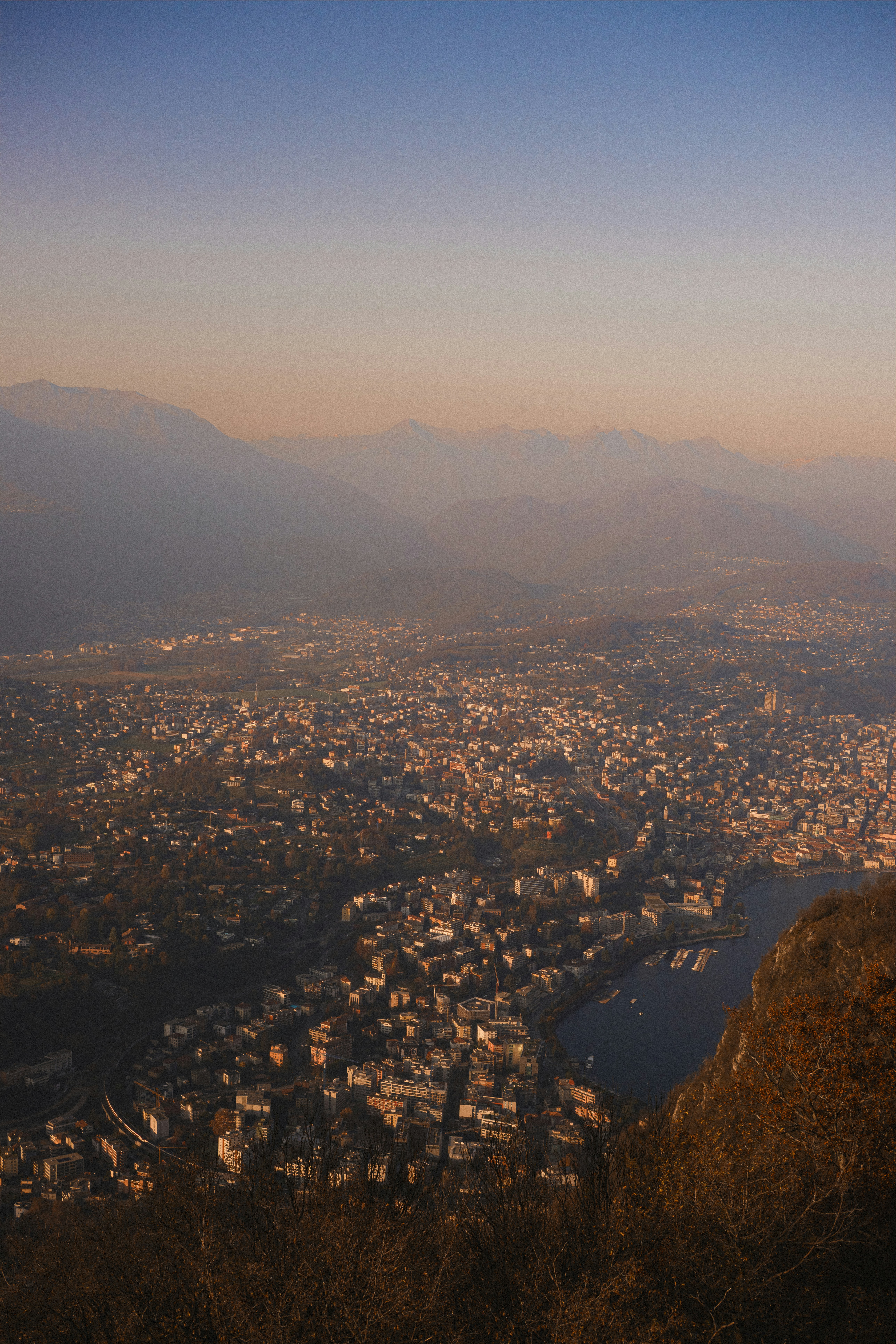 Cityscape nestled among mountains at sunset