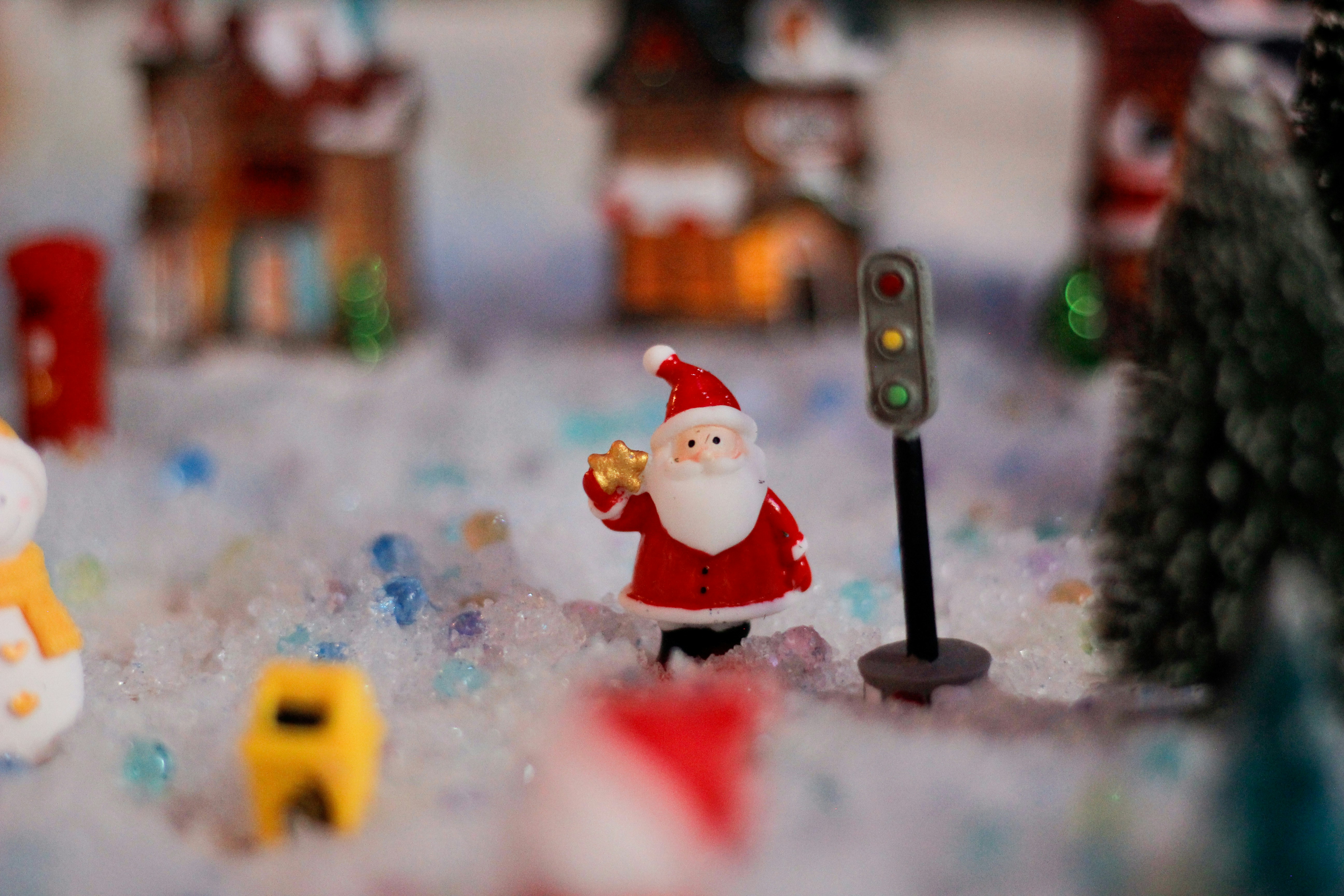 Santa claus figurine with traffic light in snow