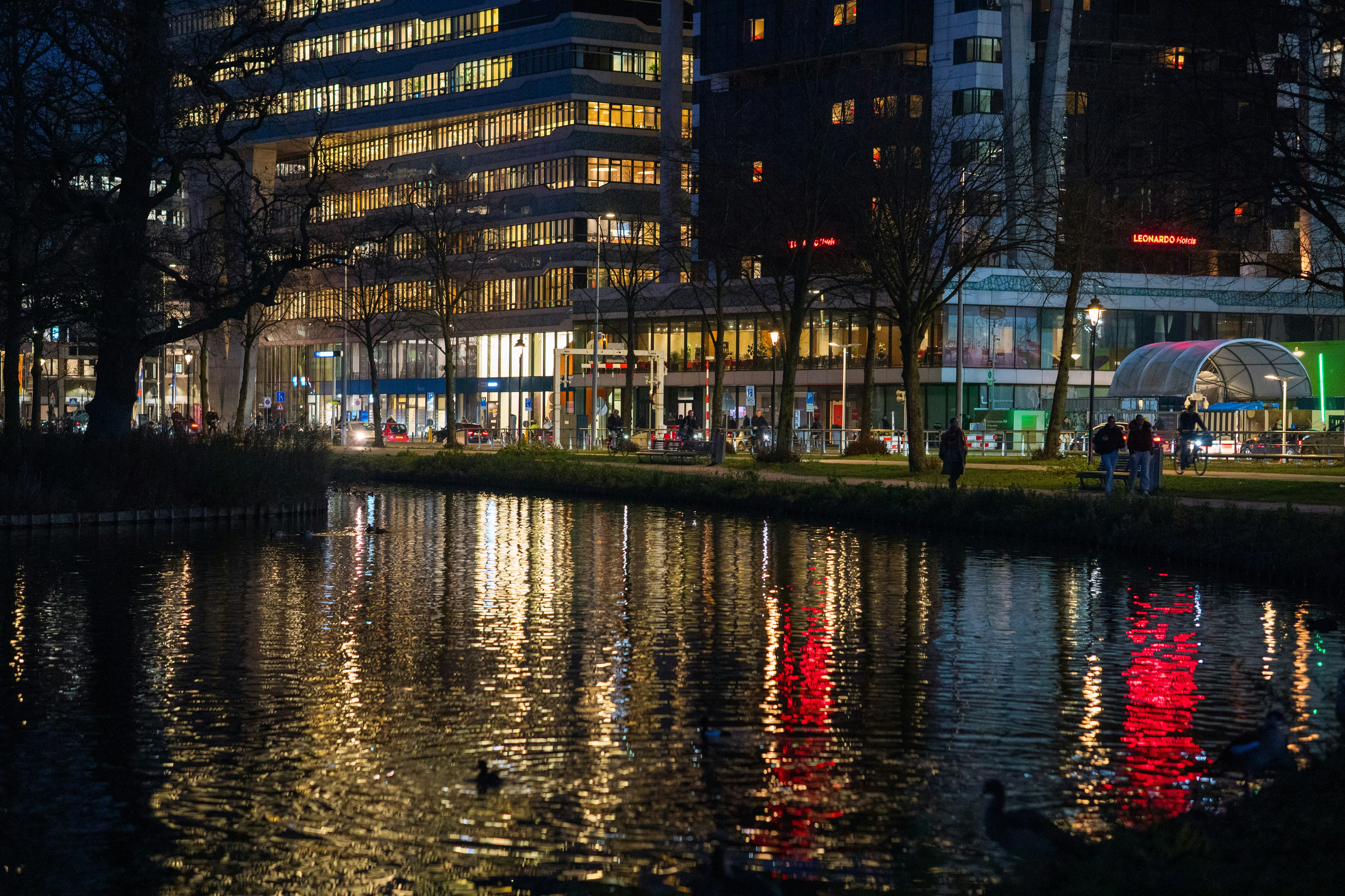 City buildings reflected in water at night