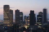 Modern skyscrapers illuminated against a dusky sky