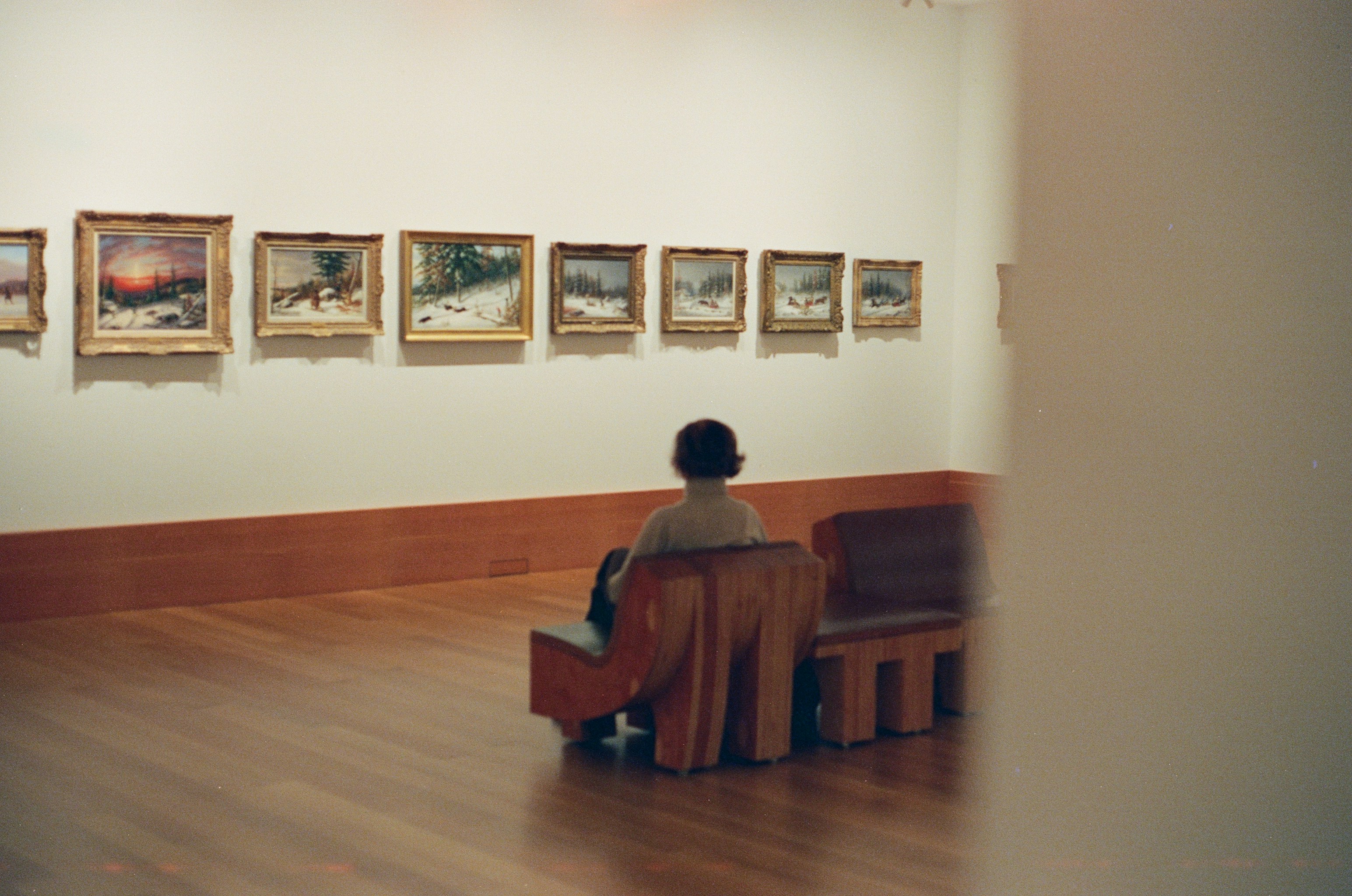 Students observing artwork in a gallery