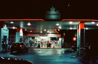 Petro-canada gas station at night with neon lights.