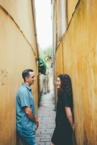 Couple standing in a narrow alleyway
