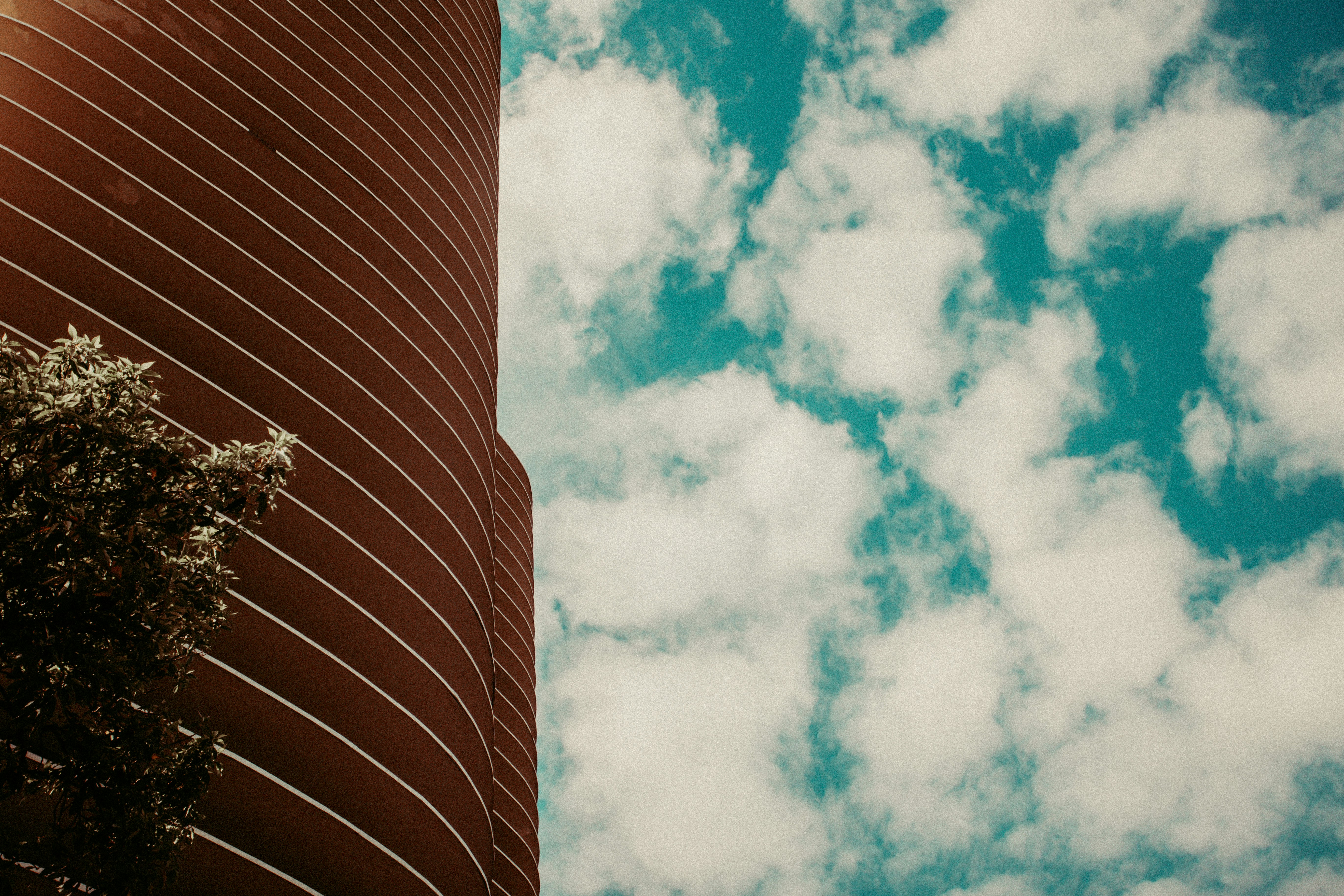 Modern skyscraper against a cloudy blue sky