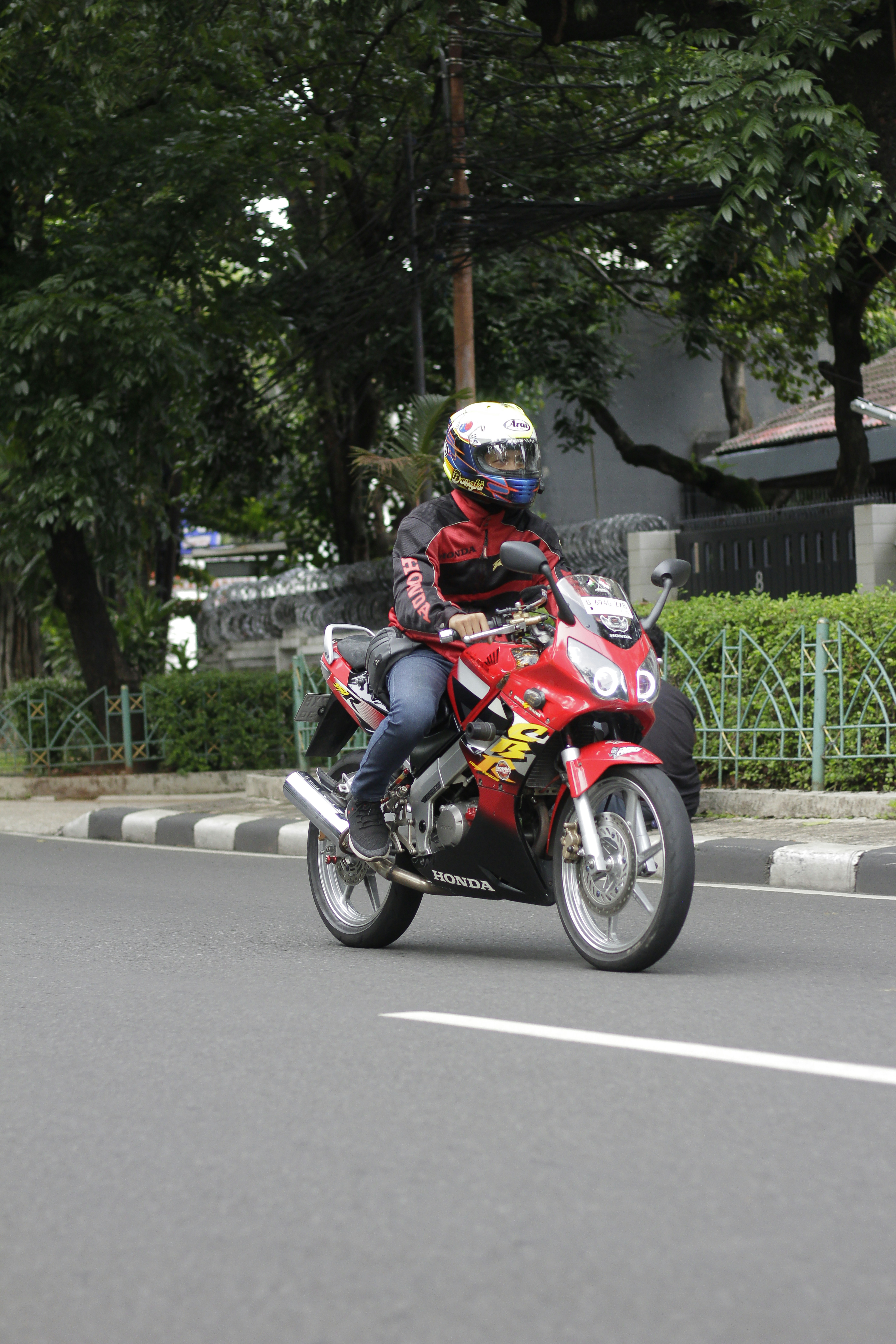 Rider on a red sport motorcycle on a street
