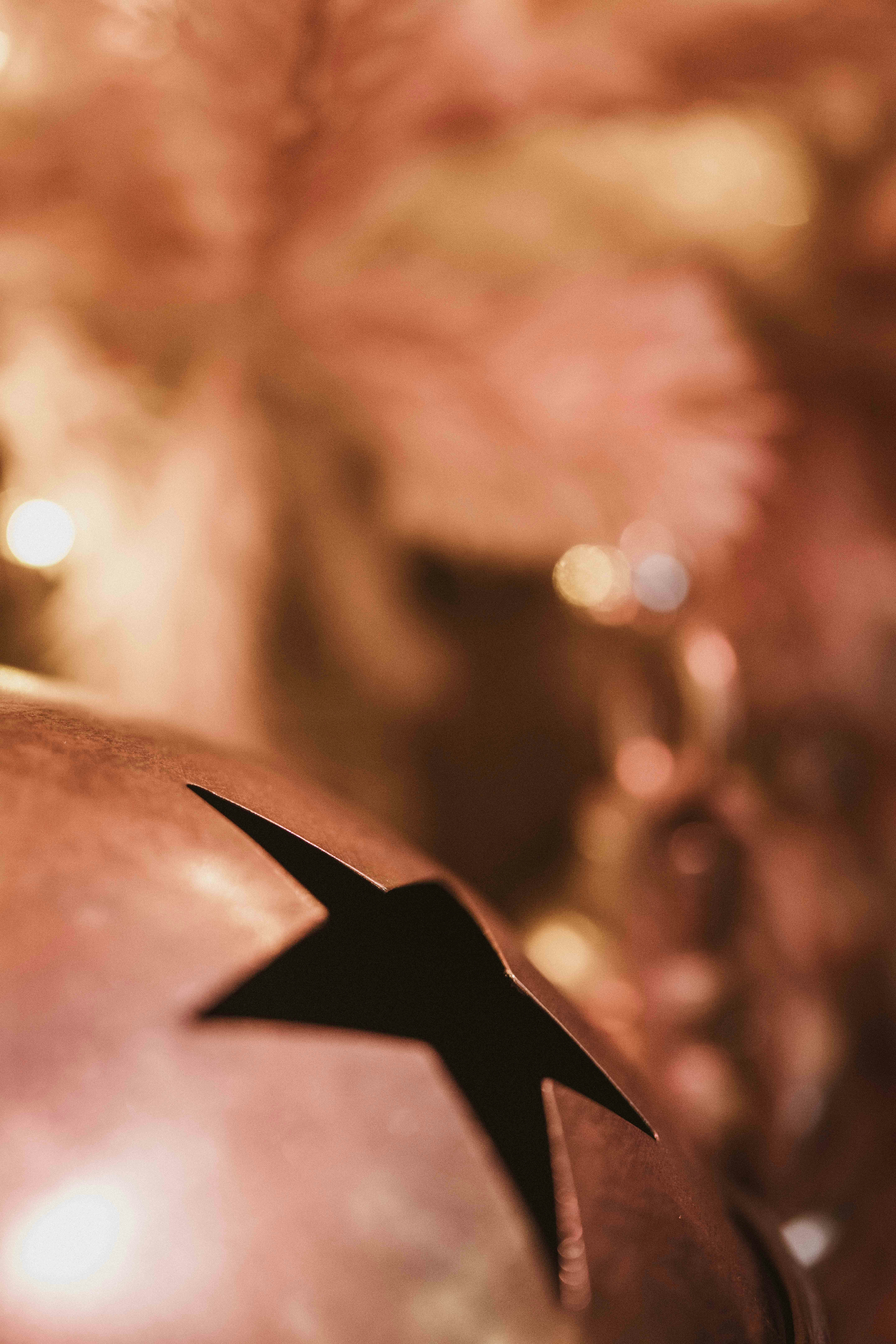 Close-up of a copper bell with a star cutout.