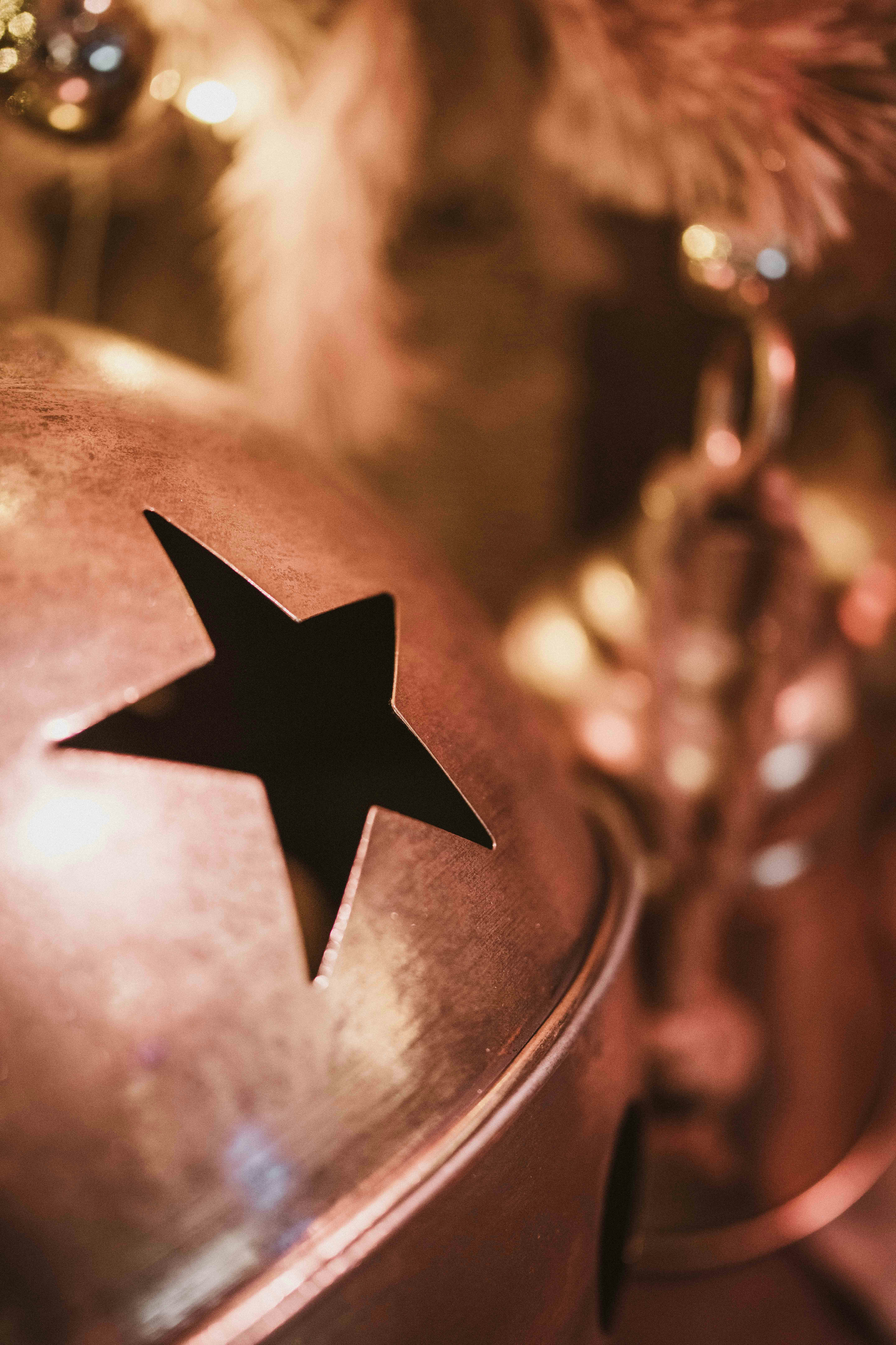 Close up of a christmas bell with a star cutout.