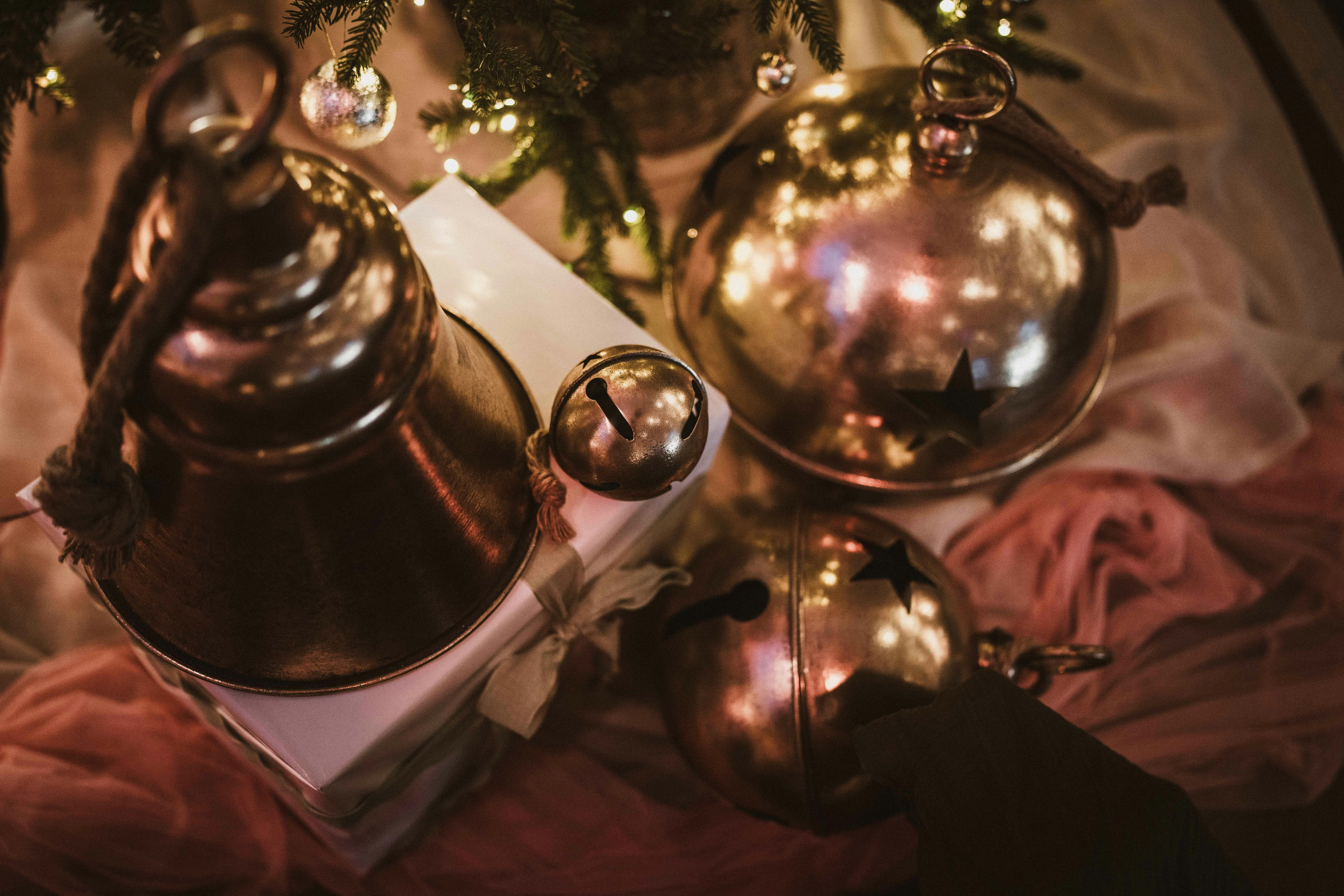 Golden christmas ornaments and bells on fabric.