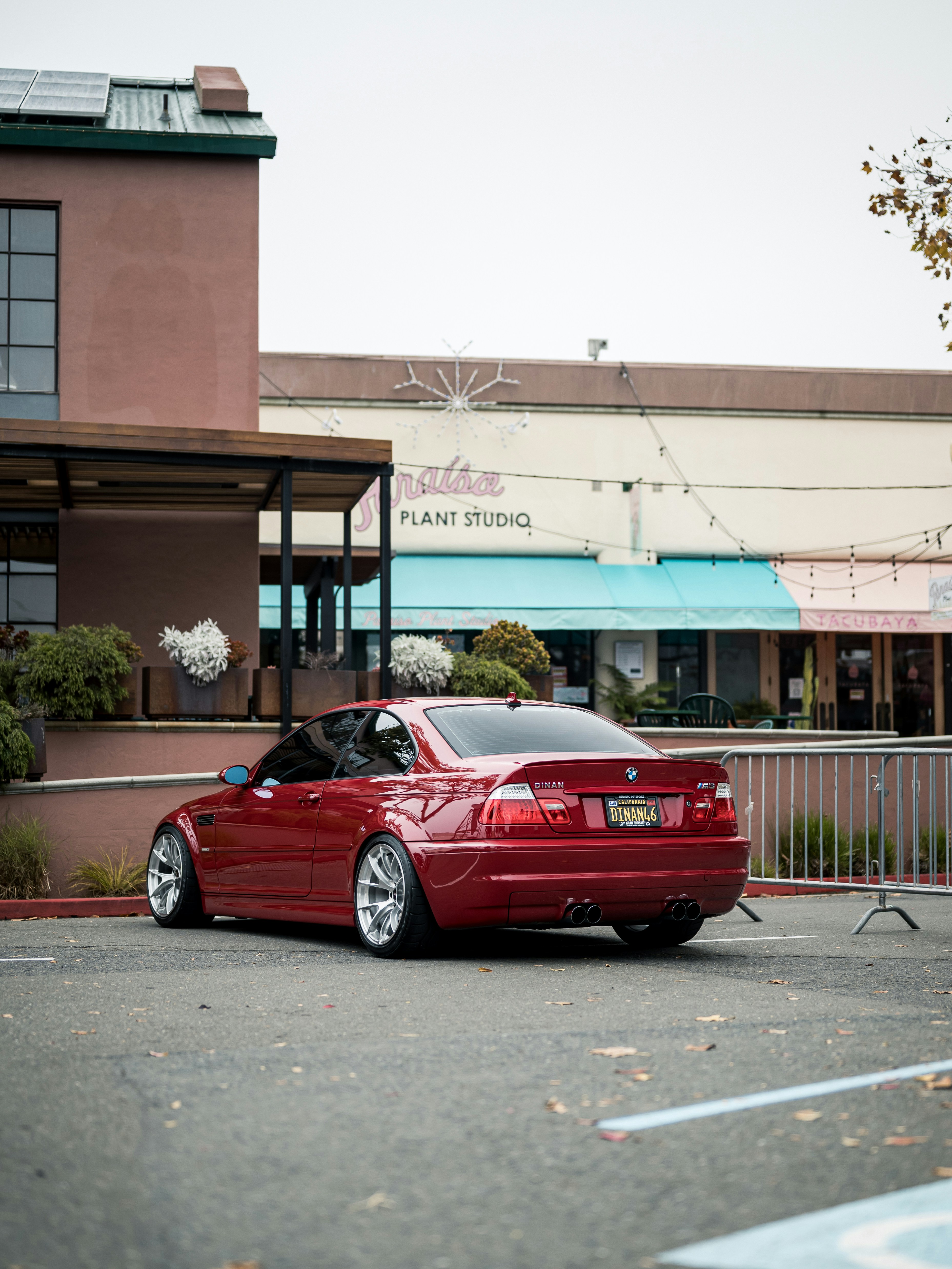 Red sports car parked outside a building.