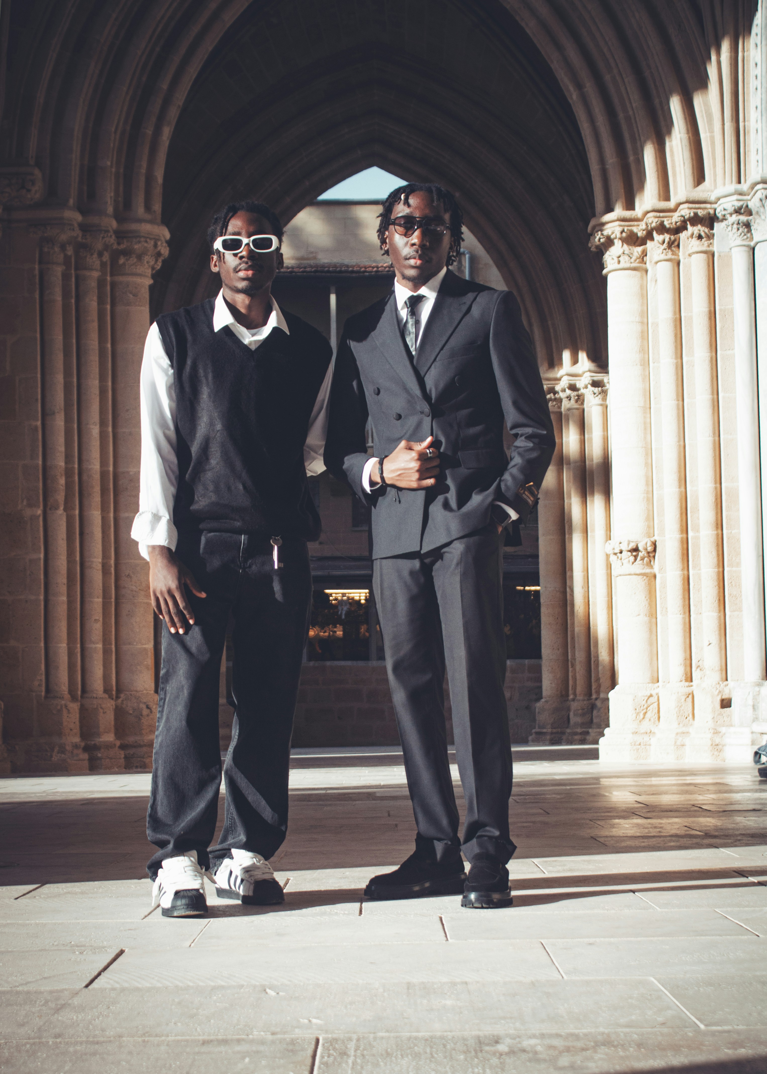 Two young men in stylish suits standing outdoors