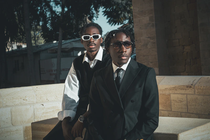 two stylish men in sunglasses outdoors
