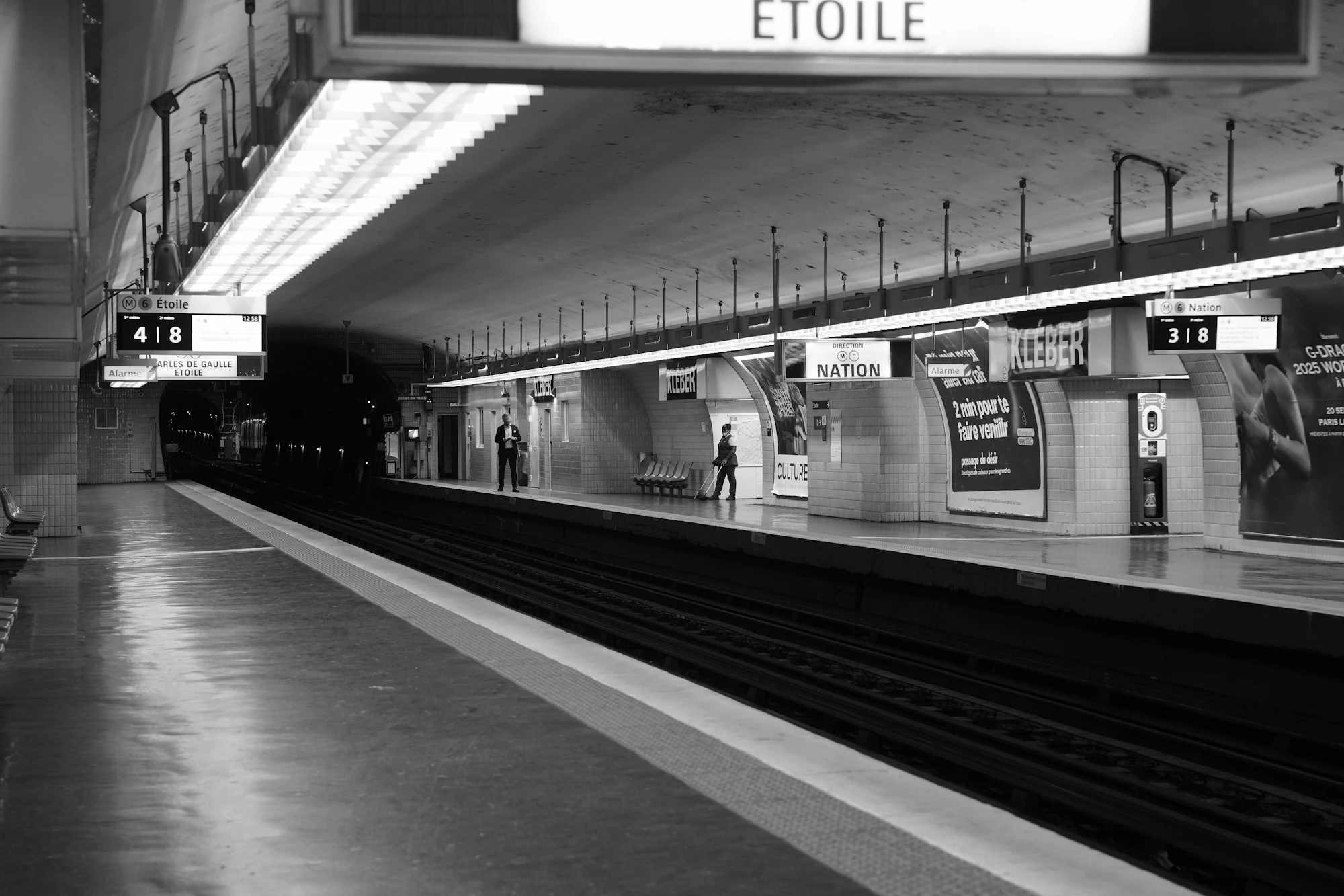 An empty metro platform at night