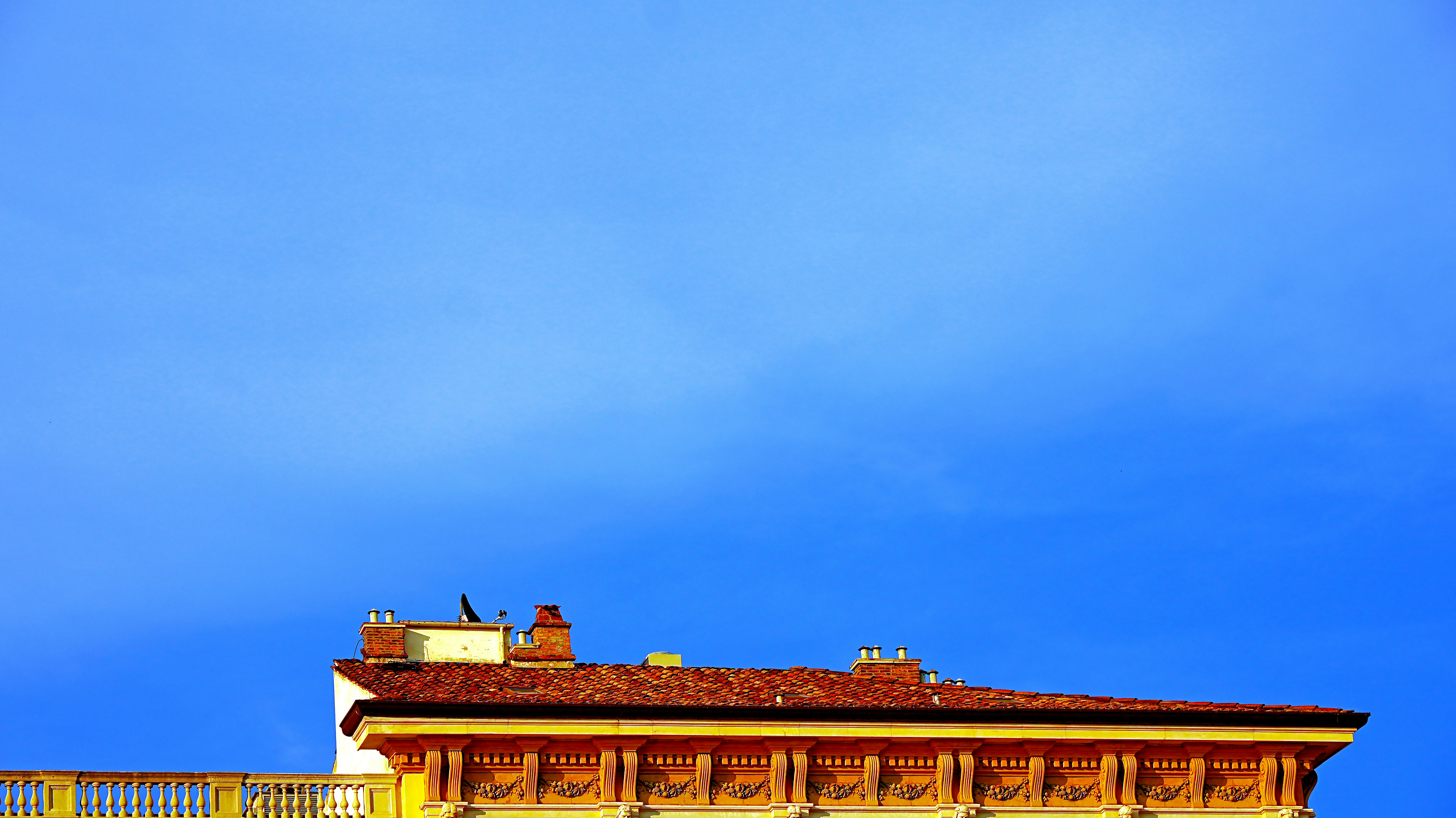 Rooftop against a clear blue sky