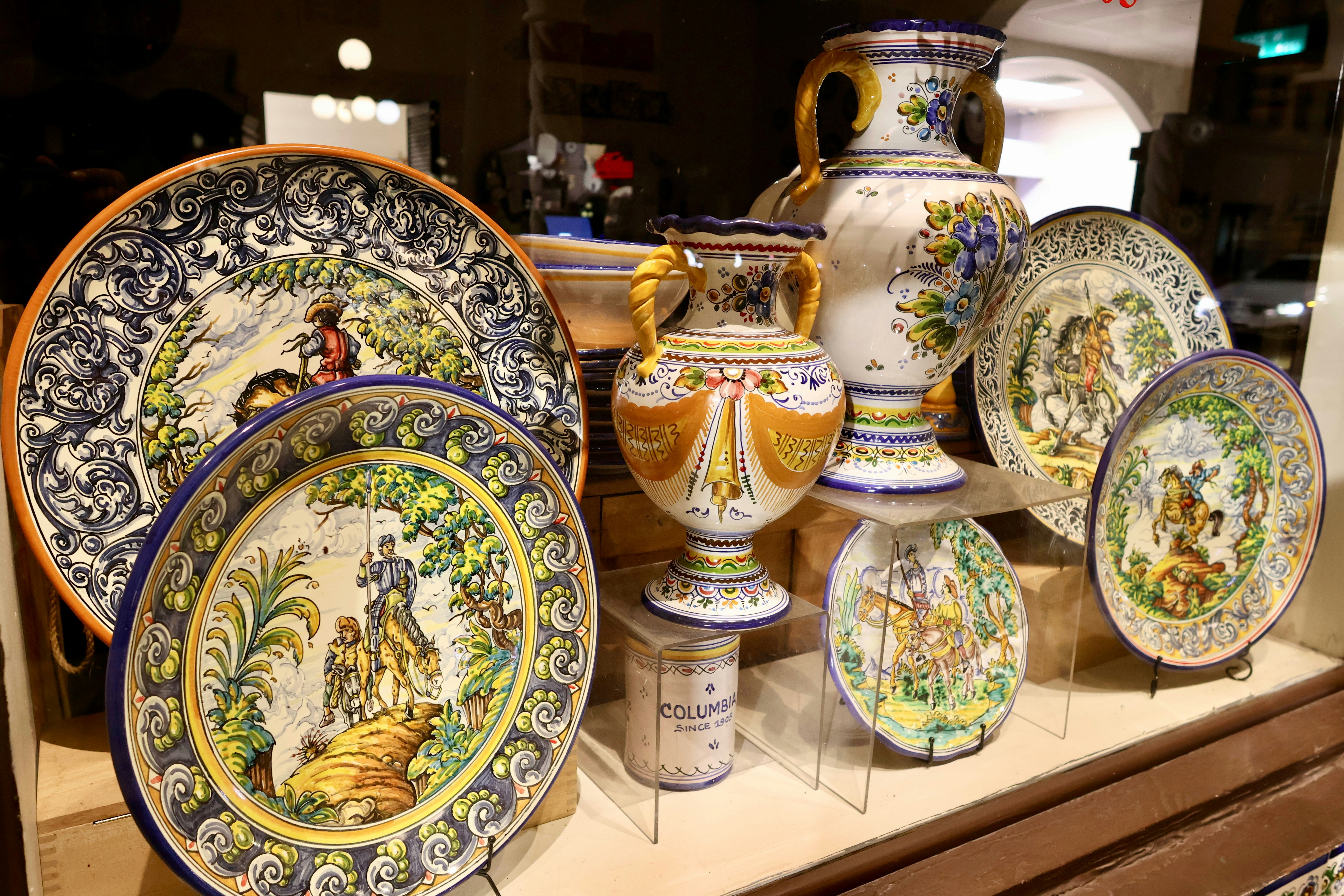 Collection of ornate ceramic plates and vases
