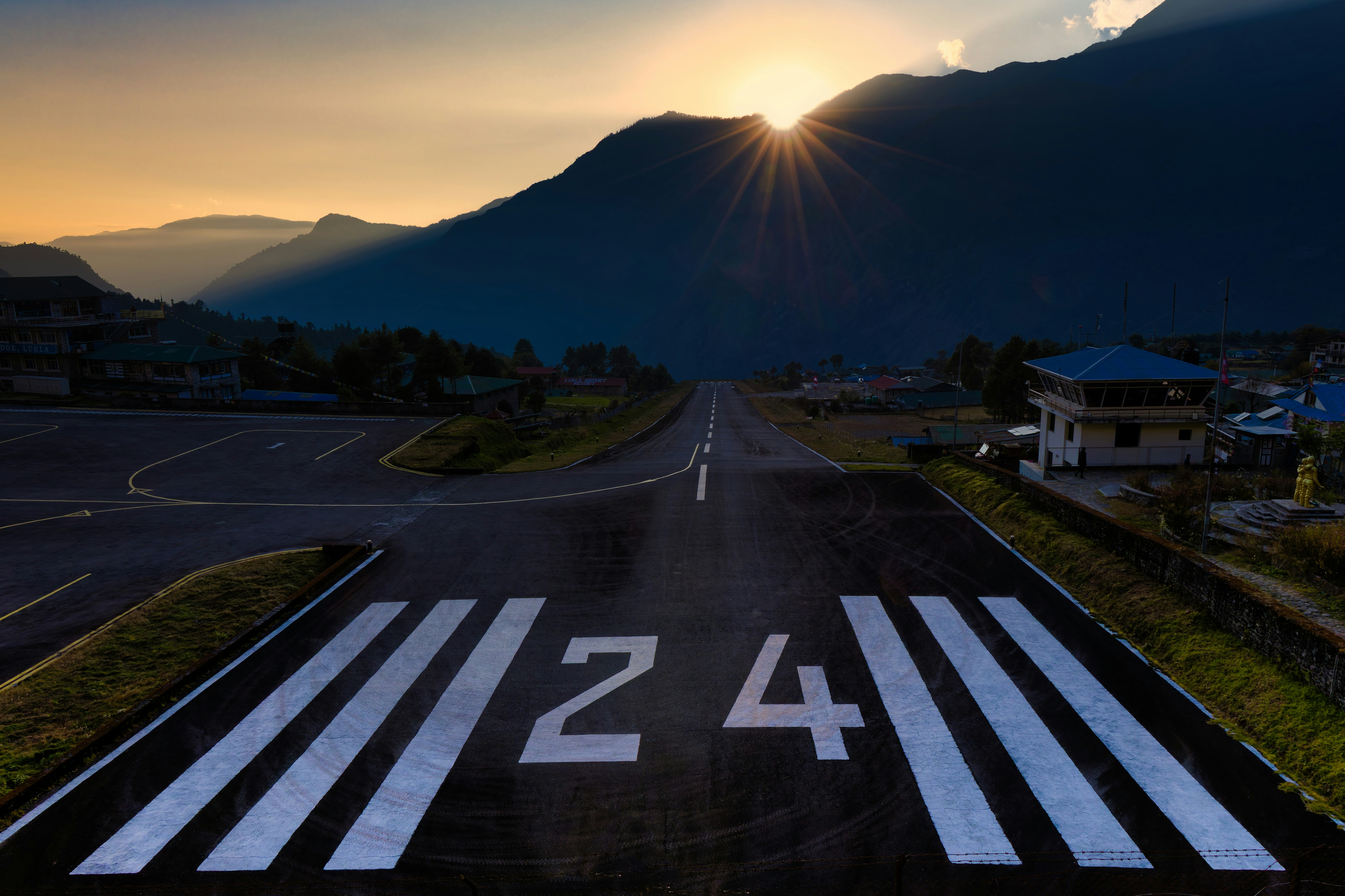 Runway number 24 at sunrise with mountains
