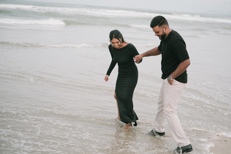Couple walking hand-in-hand on beach