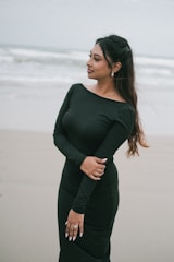 Woman in black dress on a beach