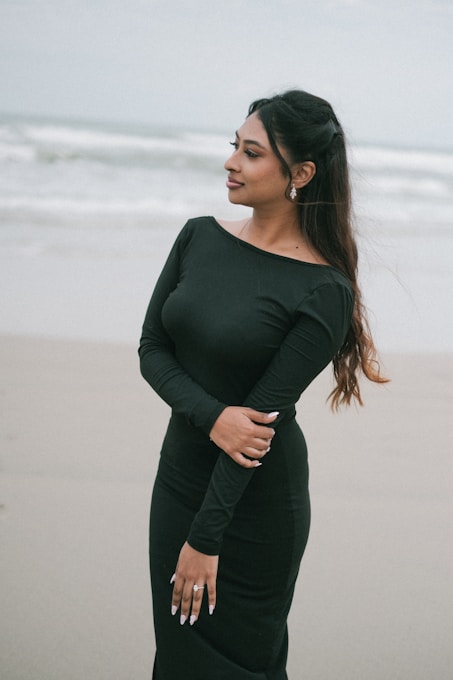 Woman in black dress on a beach