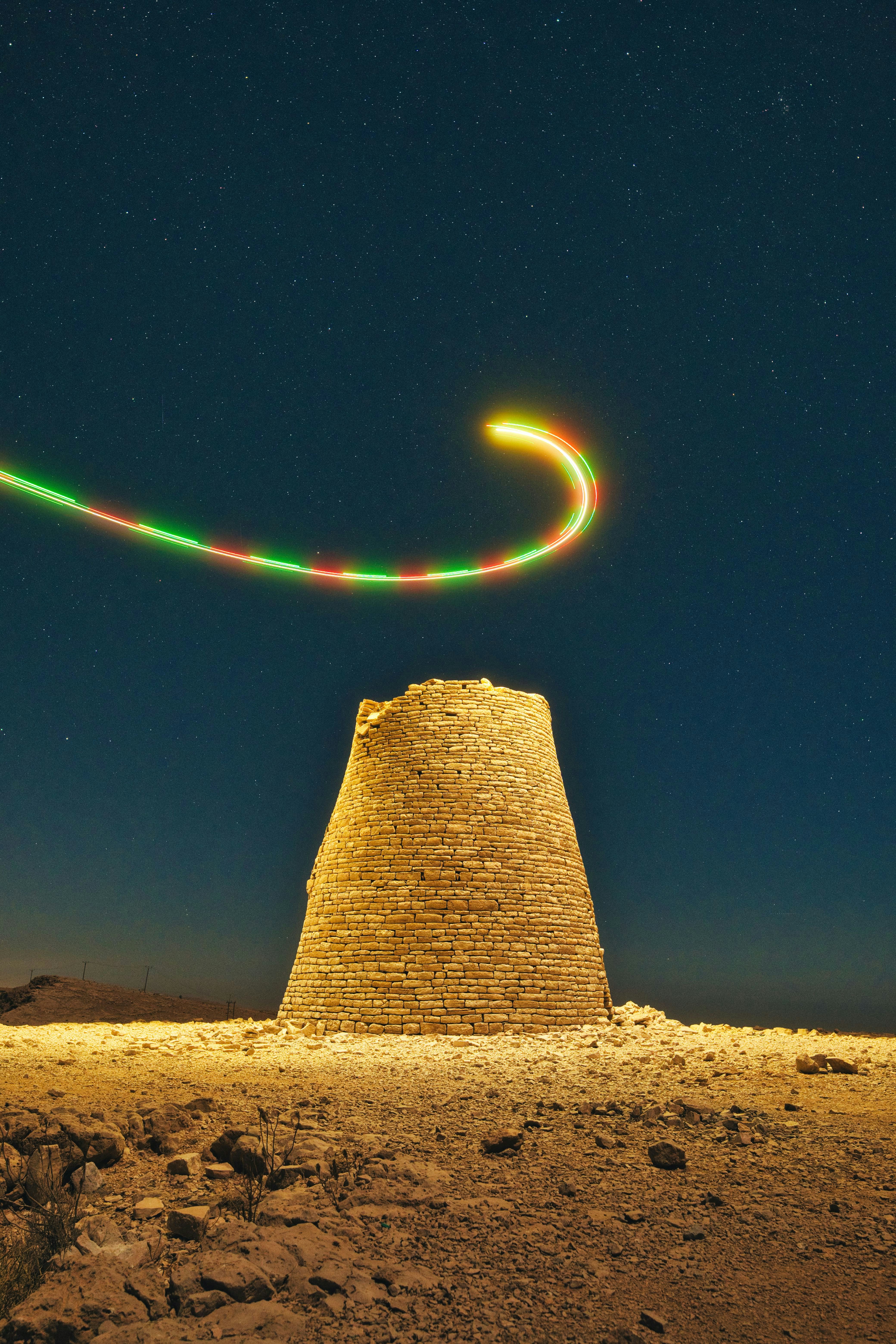 Ancient stone tower under starry night sky