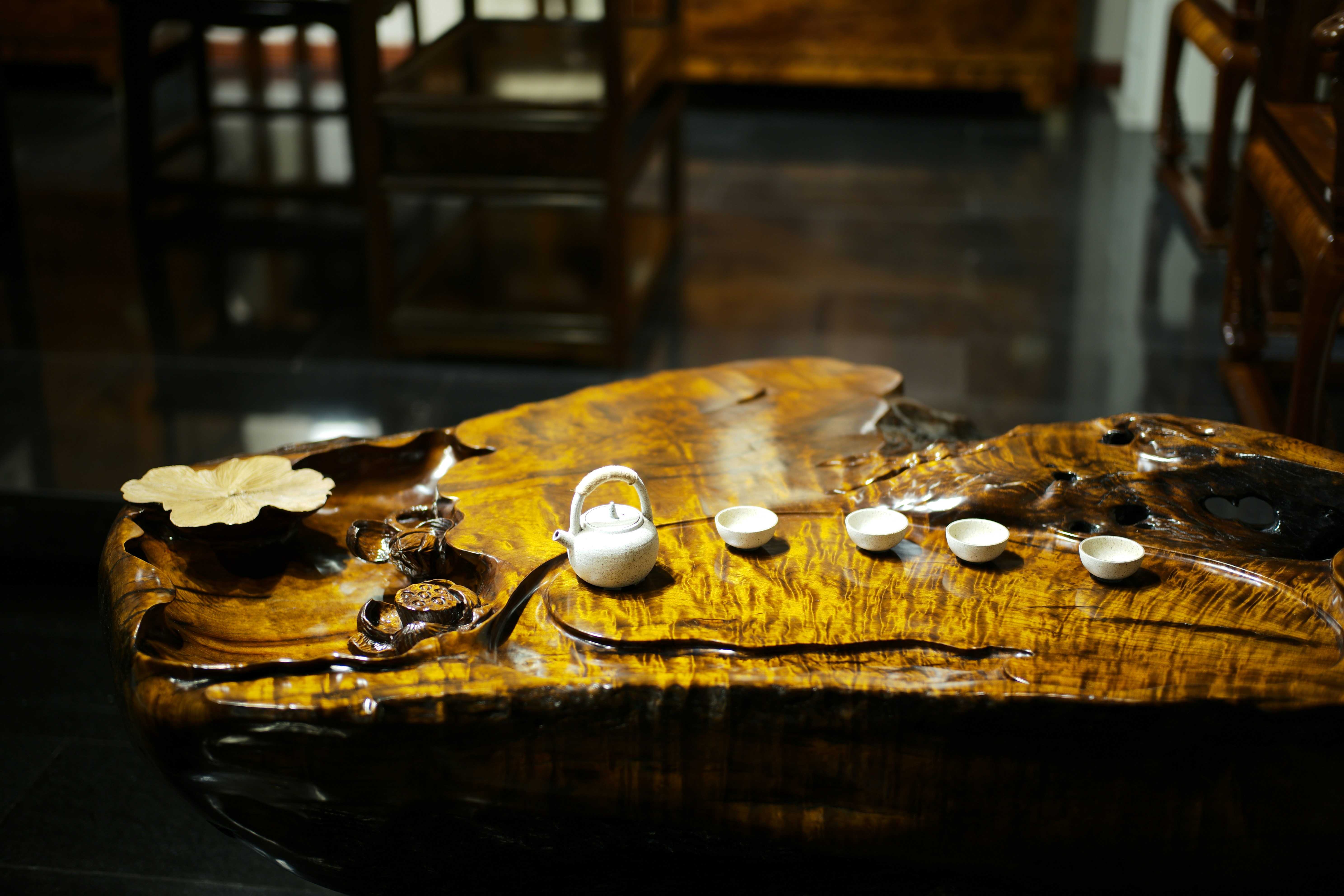 Miniature tea set on a wooden display