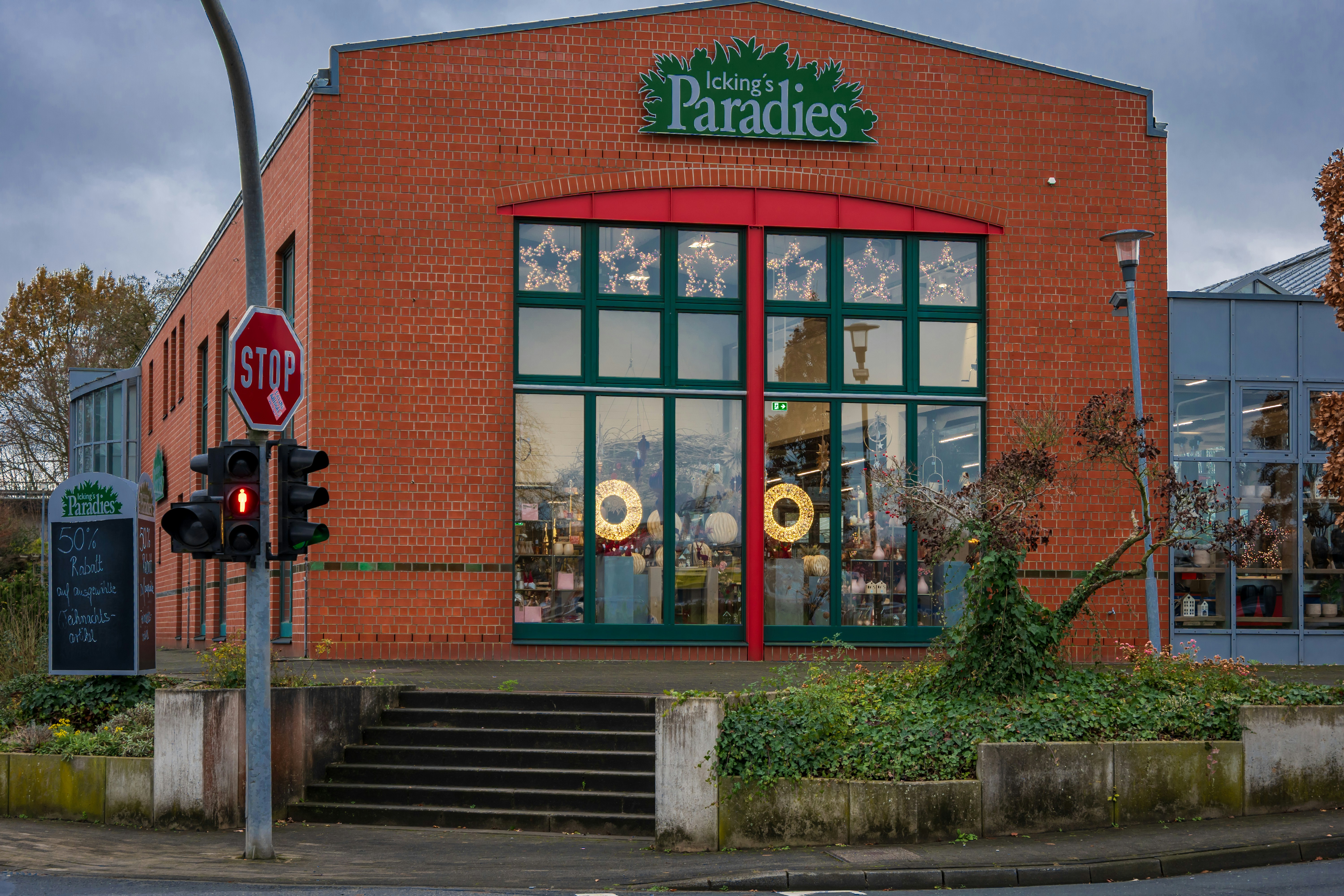 Brick building with large windows and a sign.