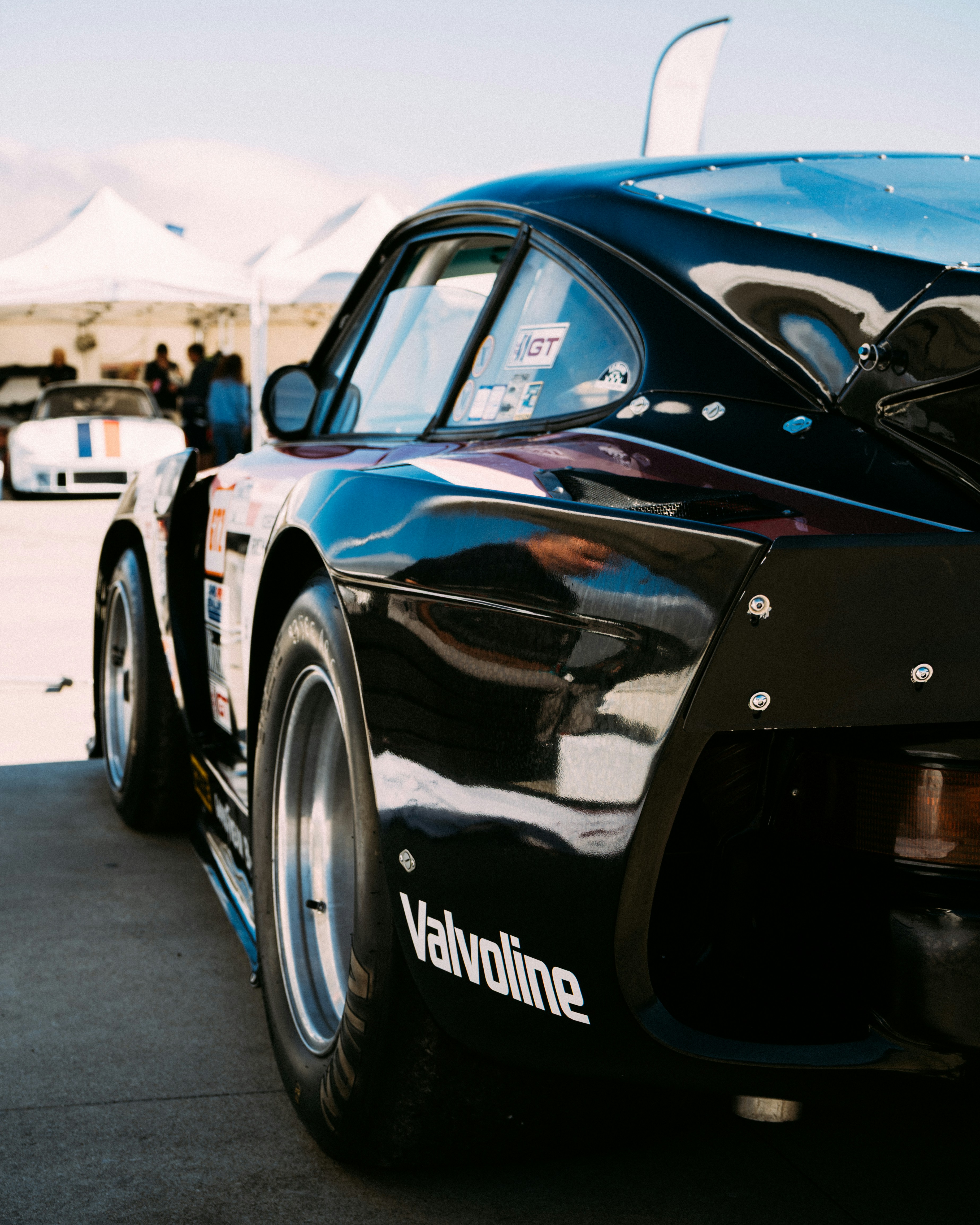 Black race car with valvoline logo on tire